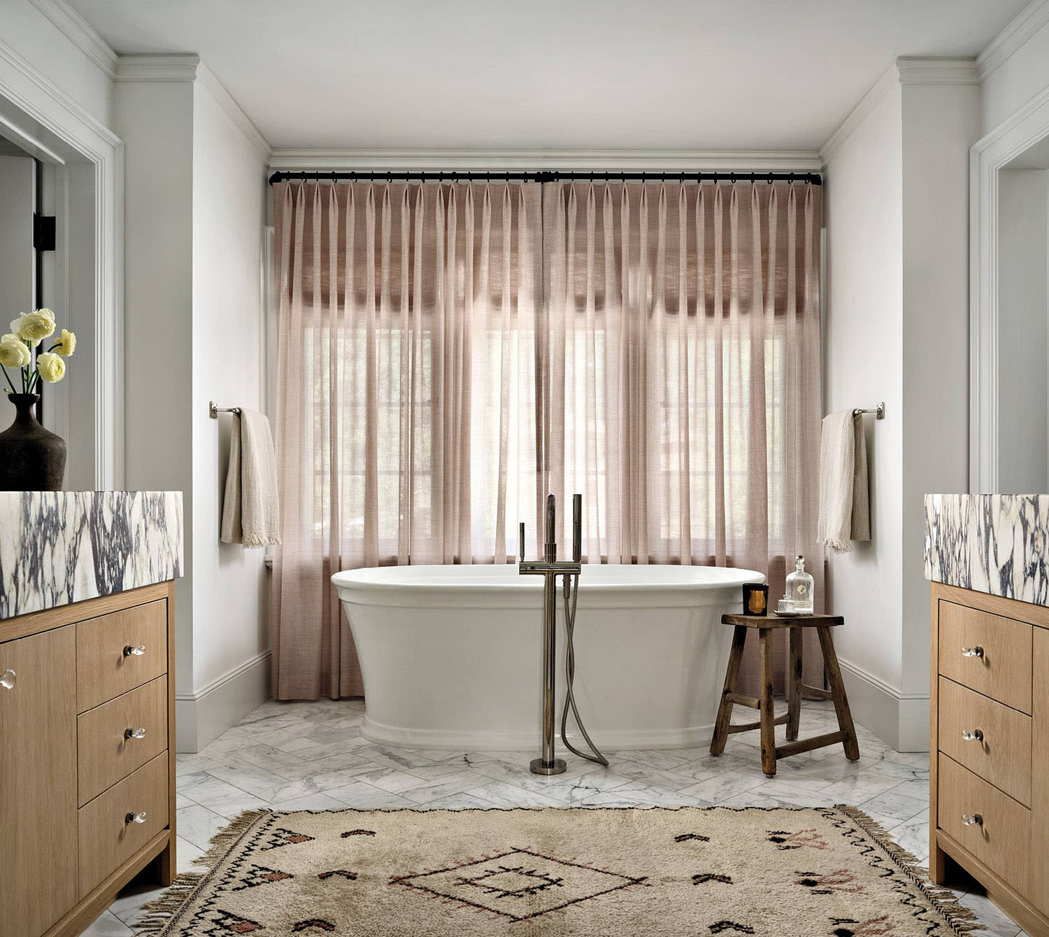 bathroom with soft-pink Bisson Bruneel linen draperies and matching white oak vanities