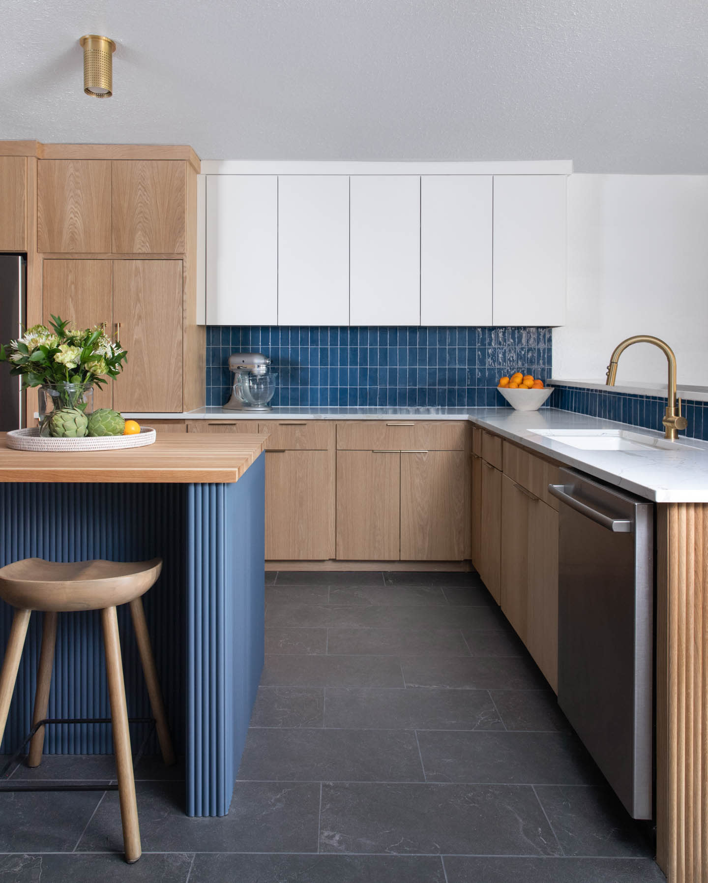 modern kitchen with light wood and blue tile