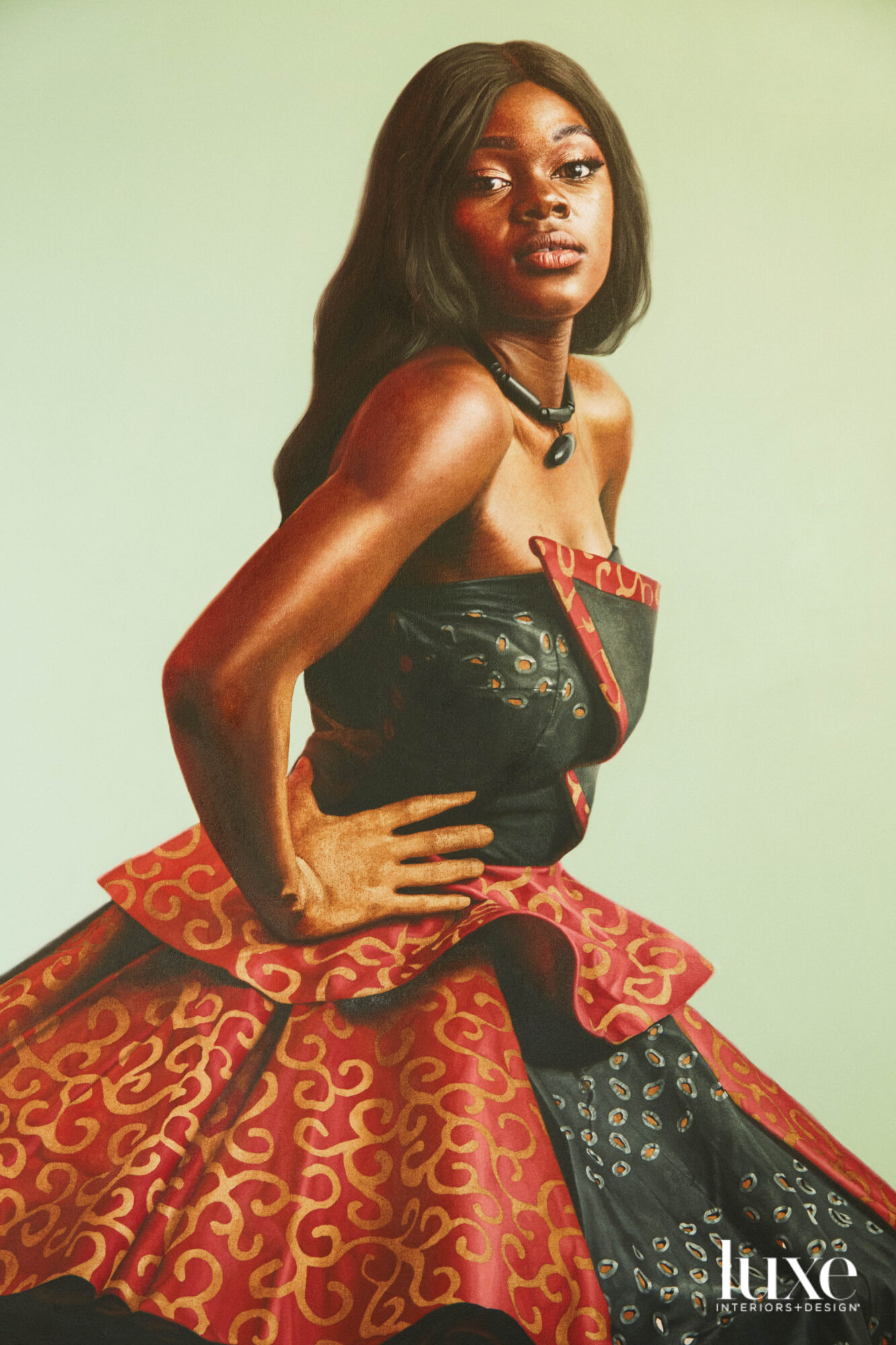 A Black woman with long hair in a black-and-red strapless dress