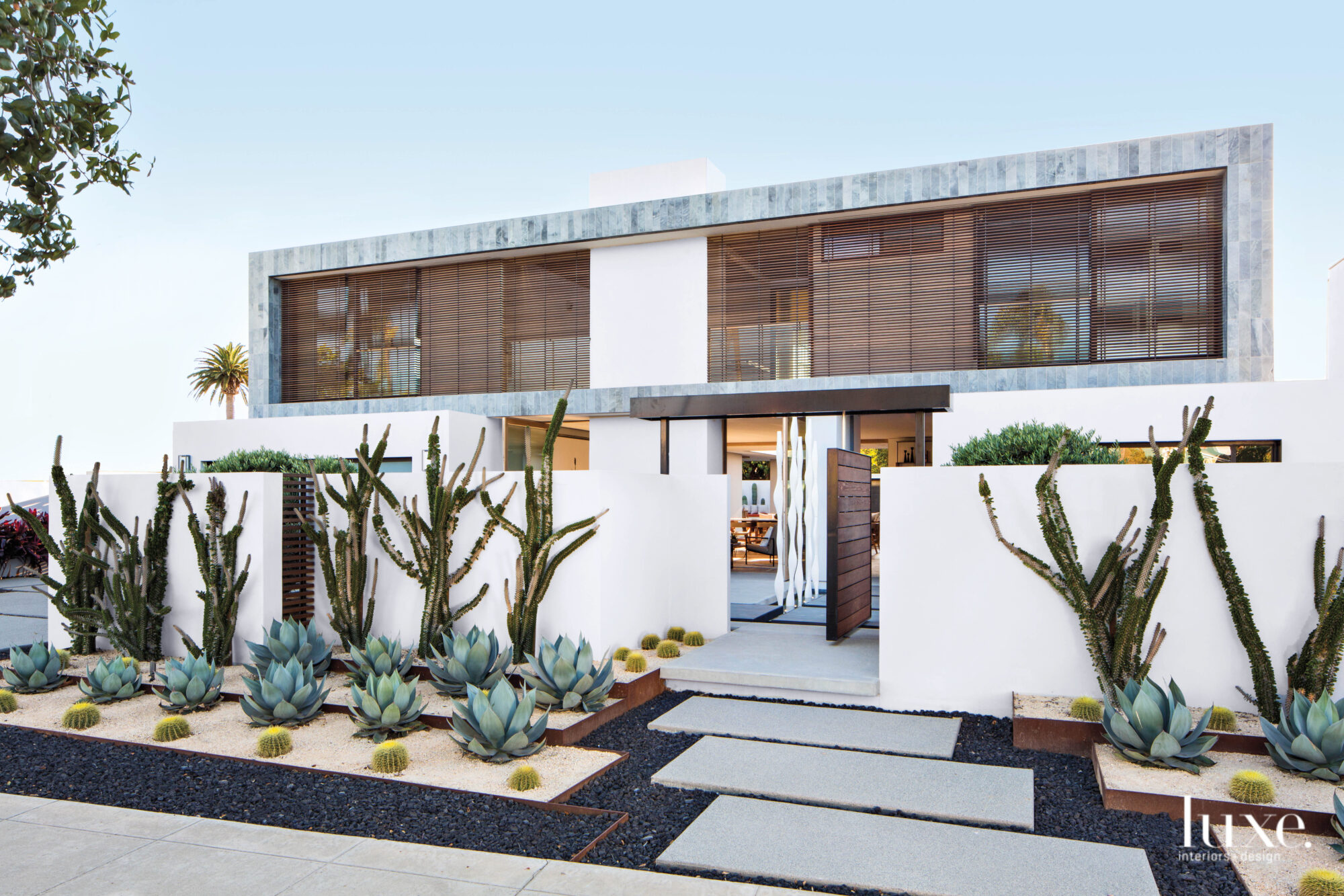 Exterior of home with louvered shades on facade