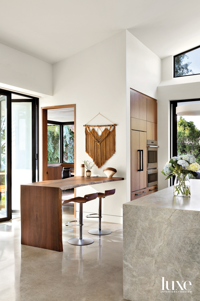 Detail of kitchen with breakfast bar and wallhanging