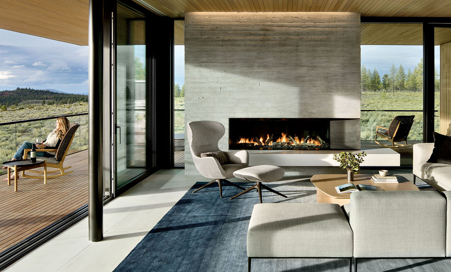 contemporary living room with a concrete fireplace 