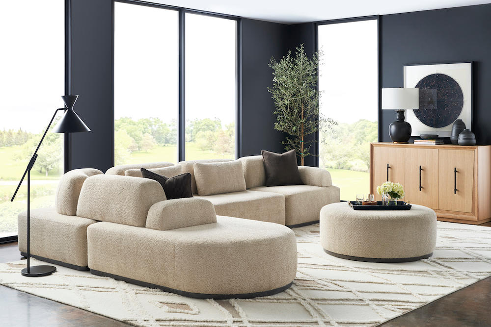 A contemporary living room with a sectional sofa and ottoman.