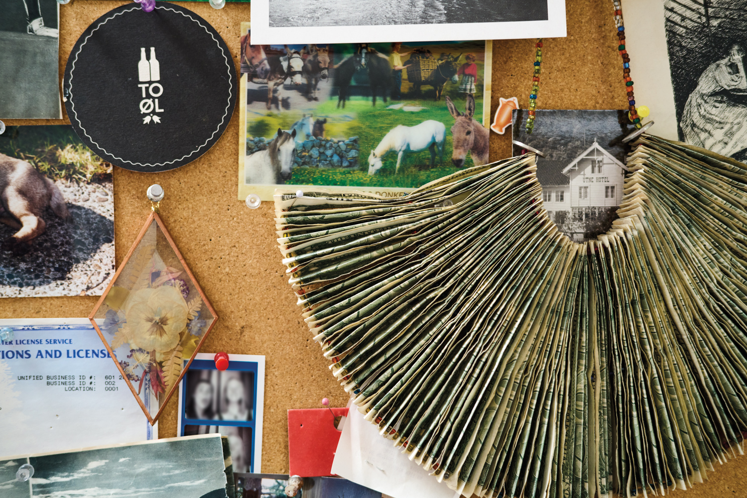 A bulletin board has several small objects on display.