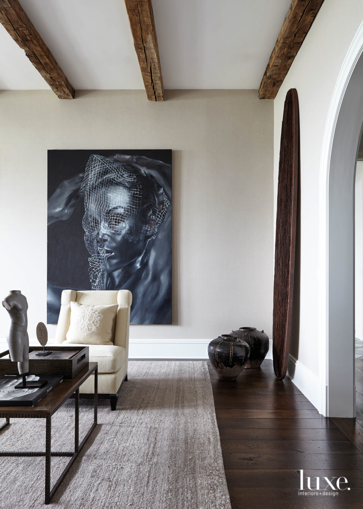 seating area with creamy linen wallcoverings and reclaimed wood beams