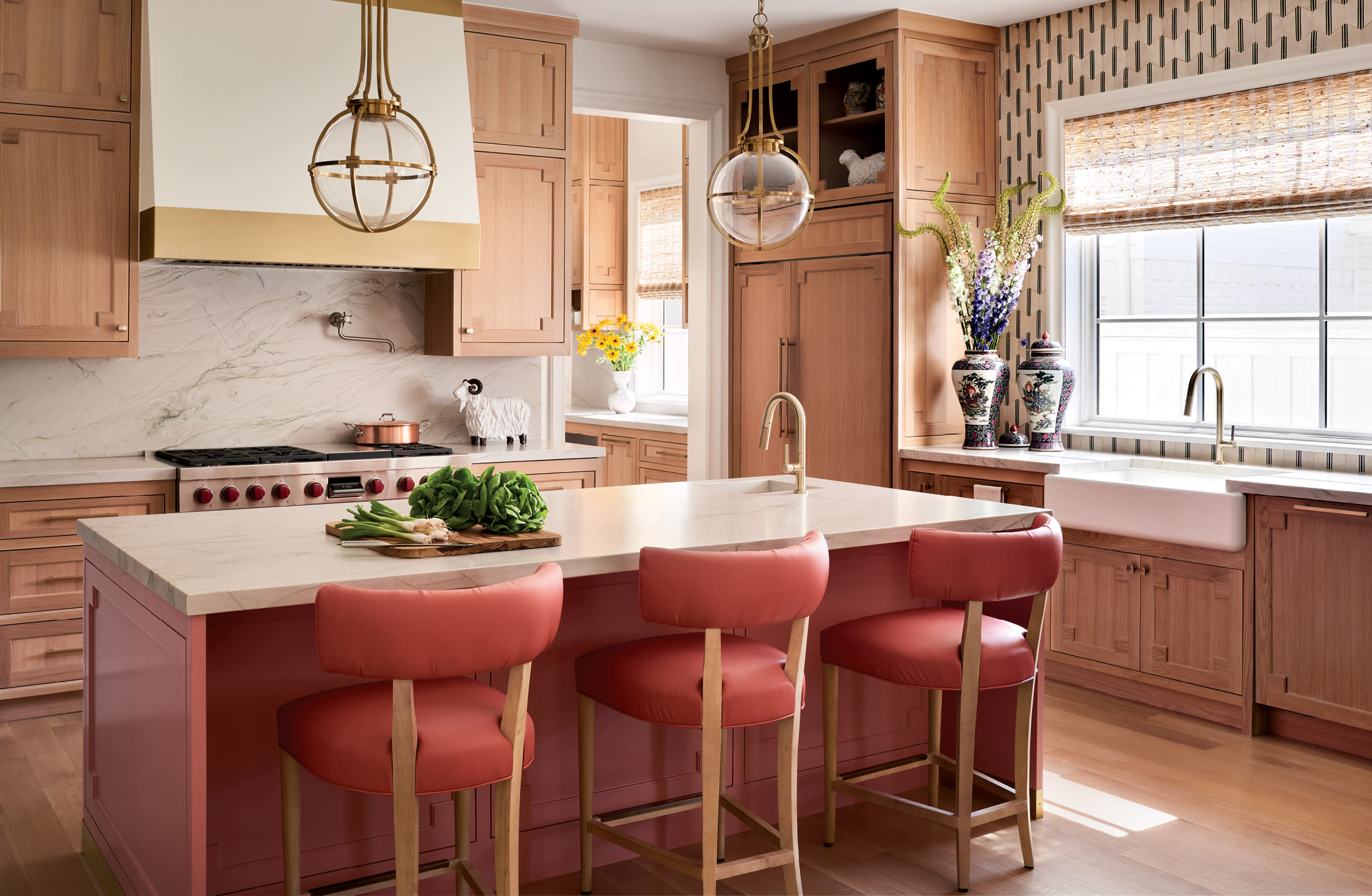 kitchen with pops of pink on the island and leather bar stools