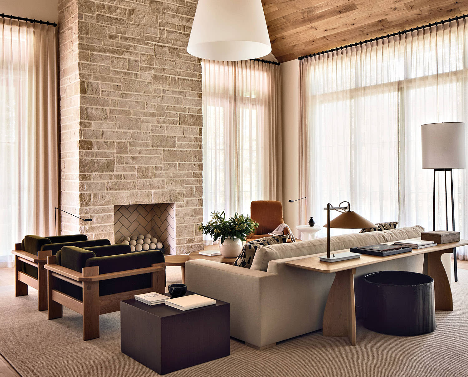limestone walled fireplace in a cozy family room