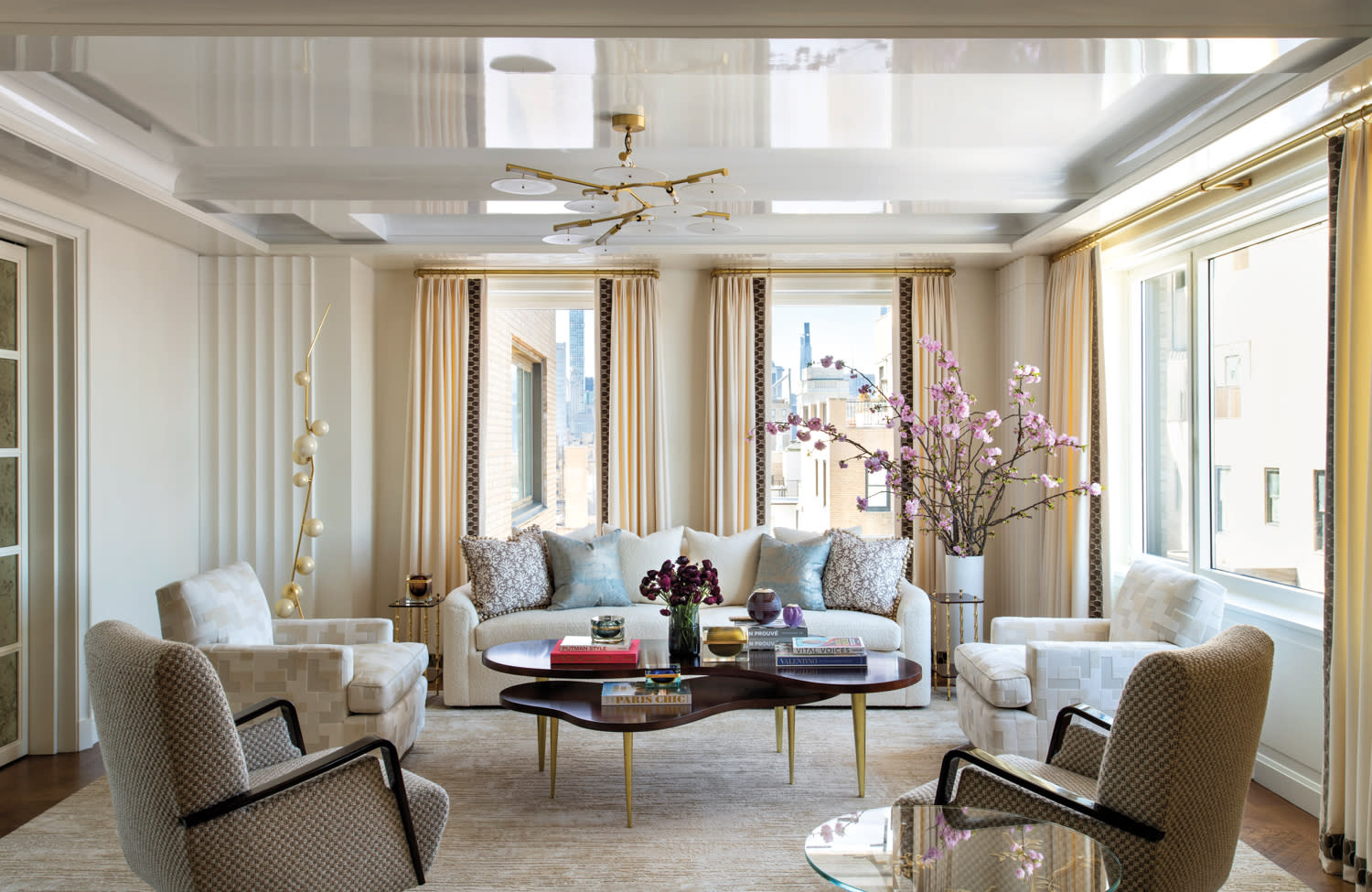 Living room with lacquered ceilings, tan drapes, Venetian plaster walls and showstopping couch in center