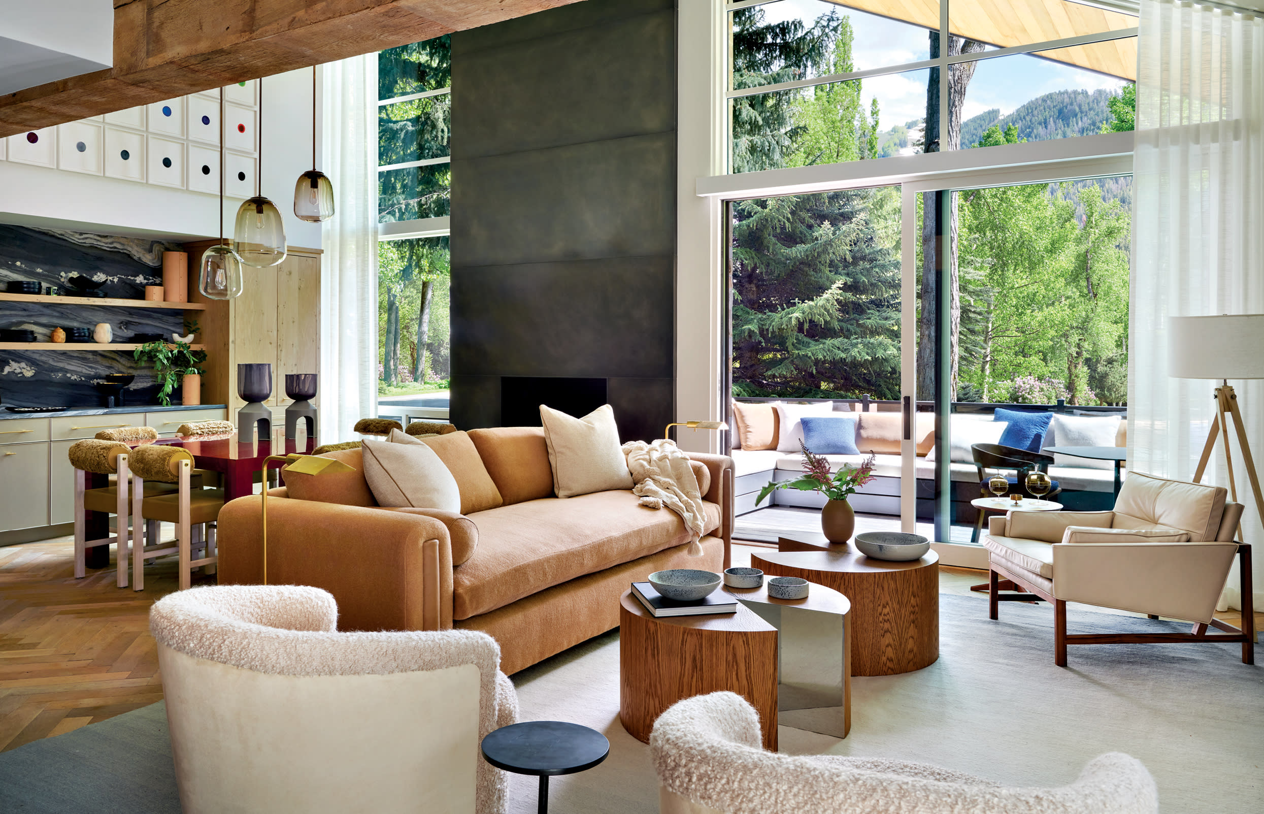 great room in an Aspen home with vaulted ceilings and a blackened steel fireplace