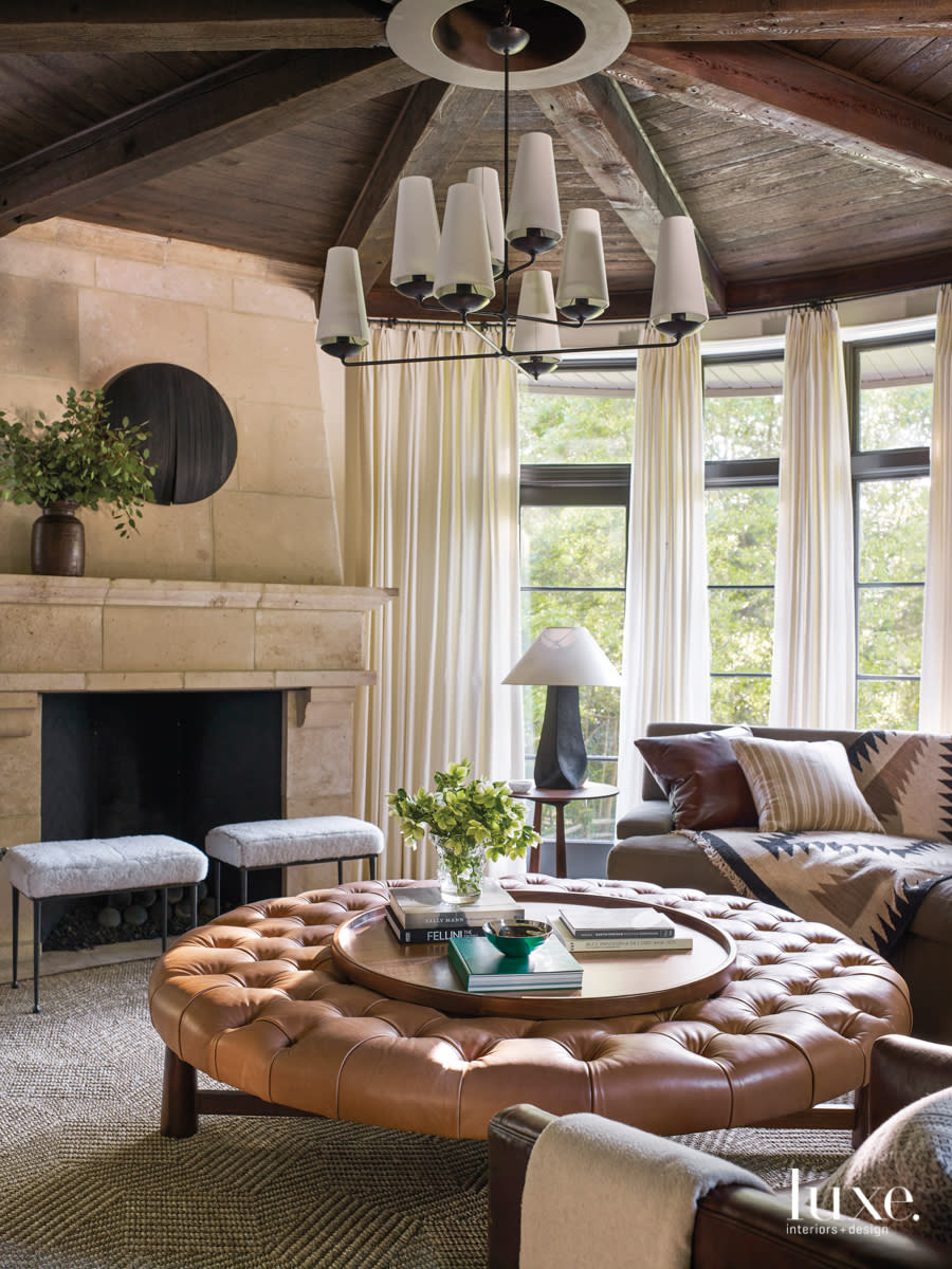sitting area with a fireplace and round fabric table to match the round room