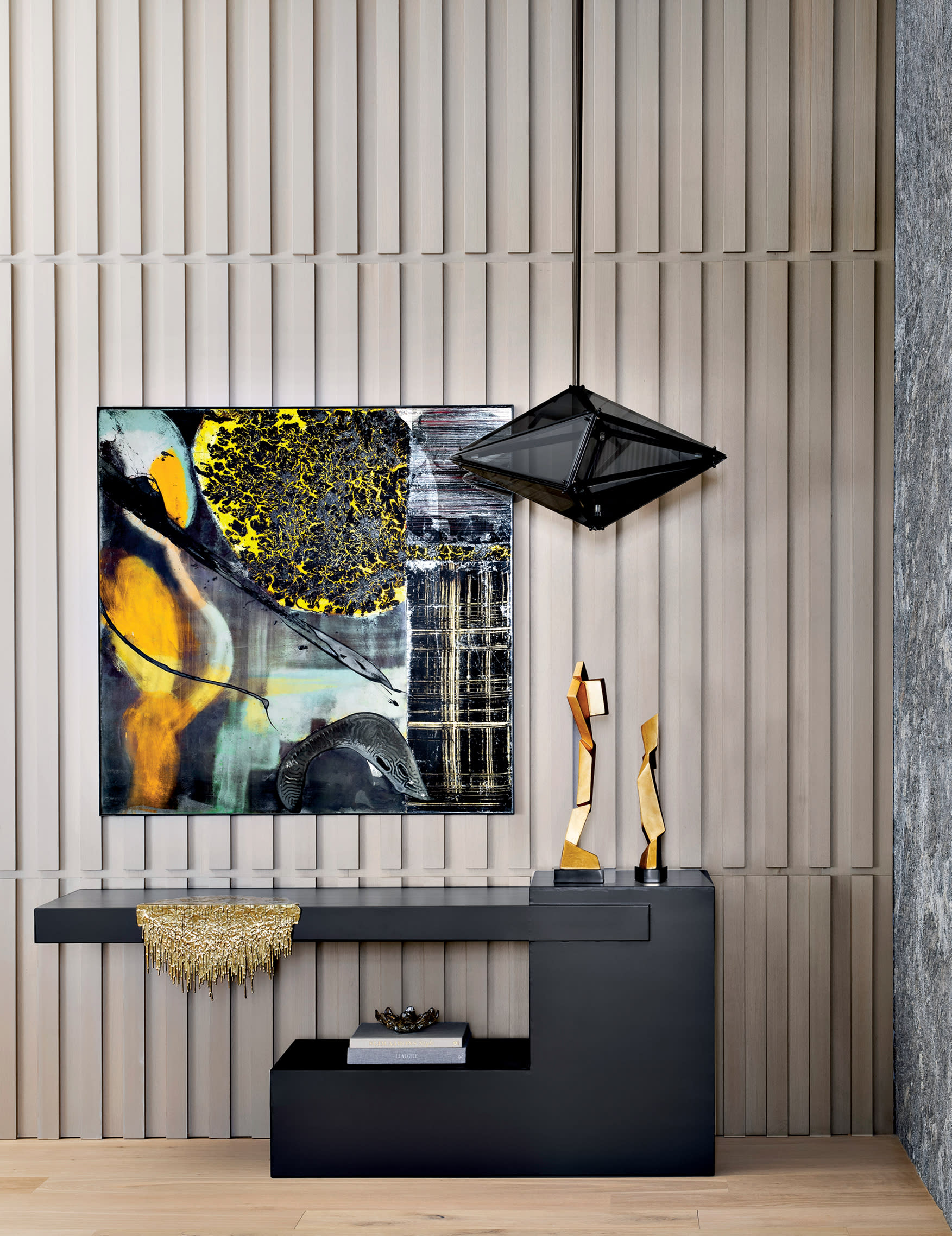 modern entryway with a ribbed oak wall and a granite table