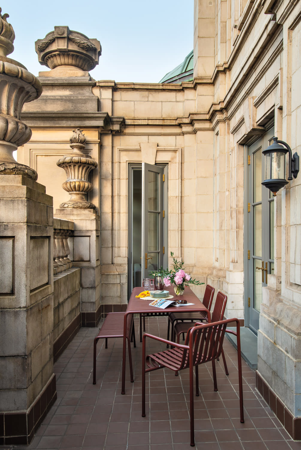 Beaux Arts exterior of an apartment building with an outdoor dining area on the terrace