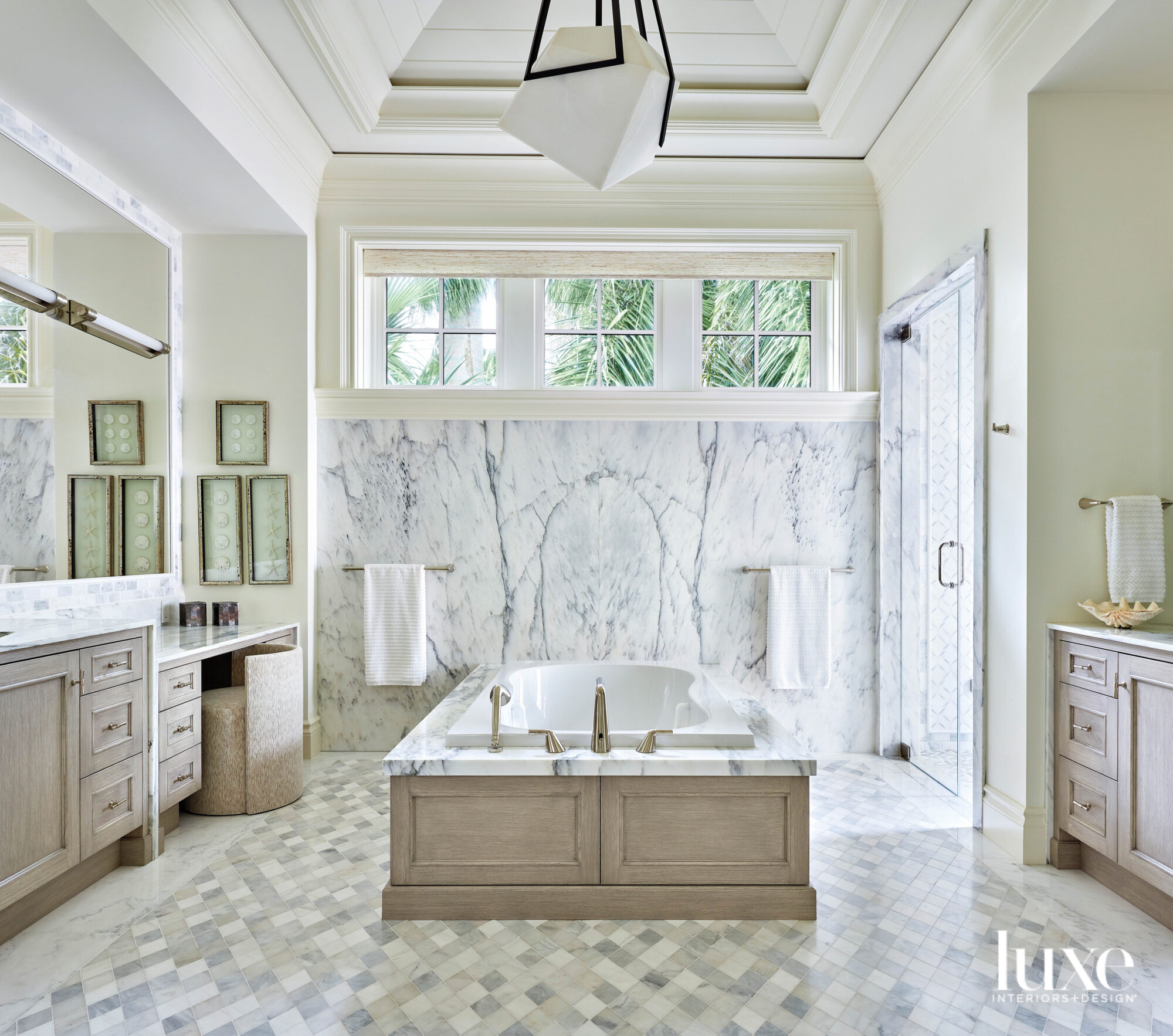 Main bathroom with marble walls and tub surround.