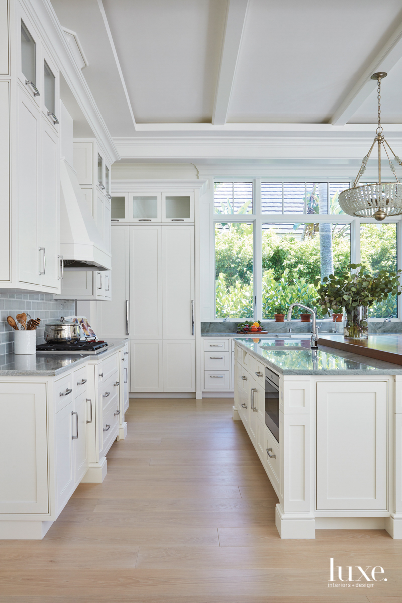 sea pearl quartzite and walnut countertop with gray-green tile backsplash