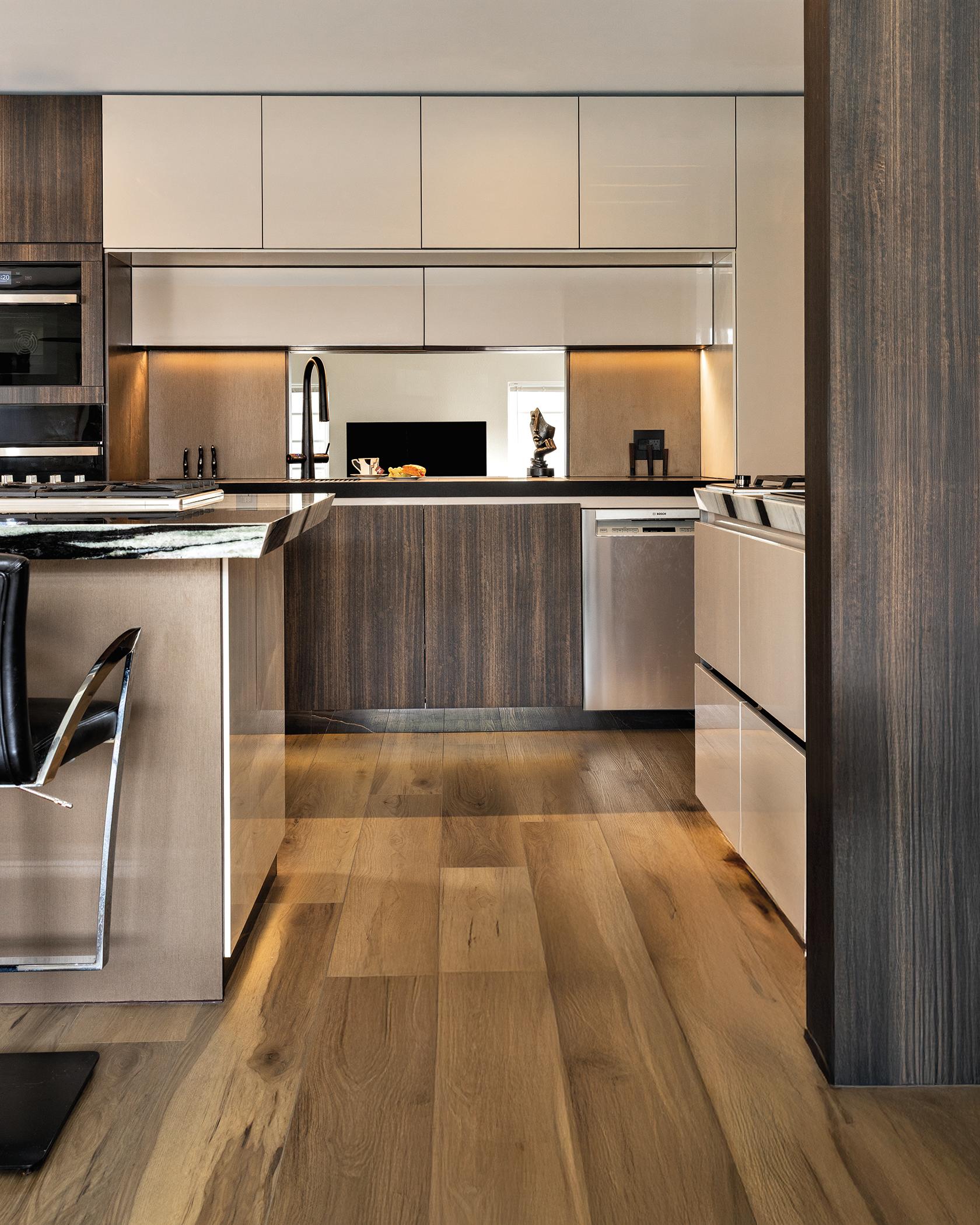 Custom cabinetry by Chic Design Group in the Pazzam Project, featuring creamy lacquered flat panels, exotic wood accents, and furniture-like detailing.