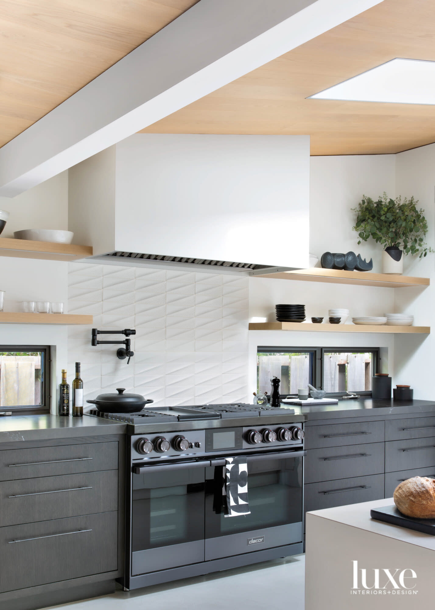 kitchen with black range and floating shelves