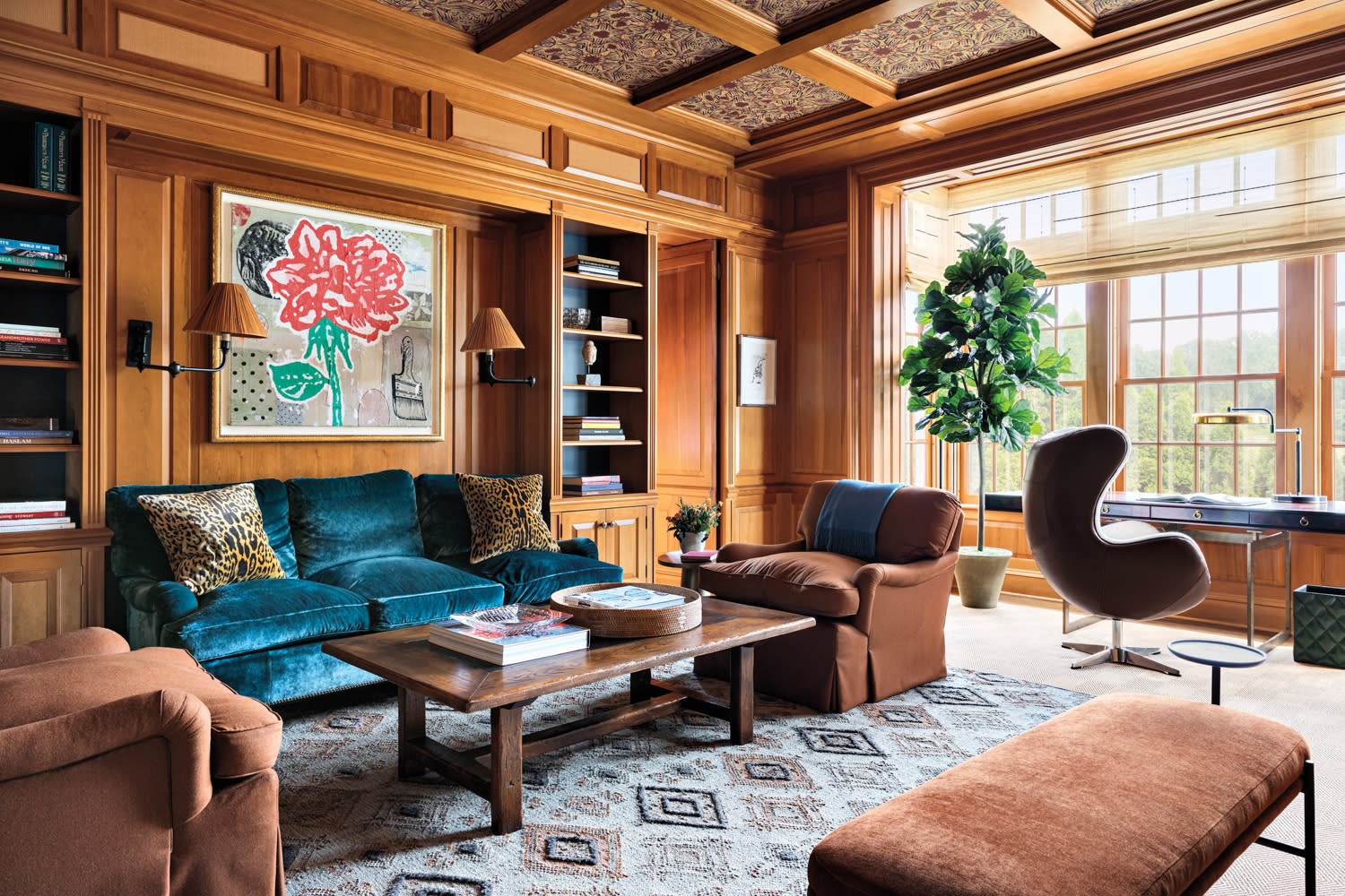 wood-paneled den with velvet teal sofa in a Connecticut home