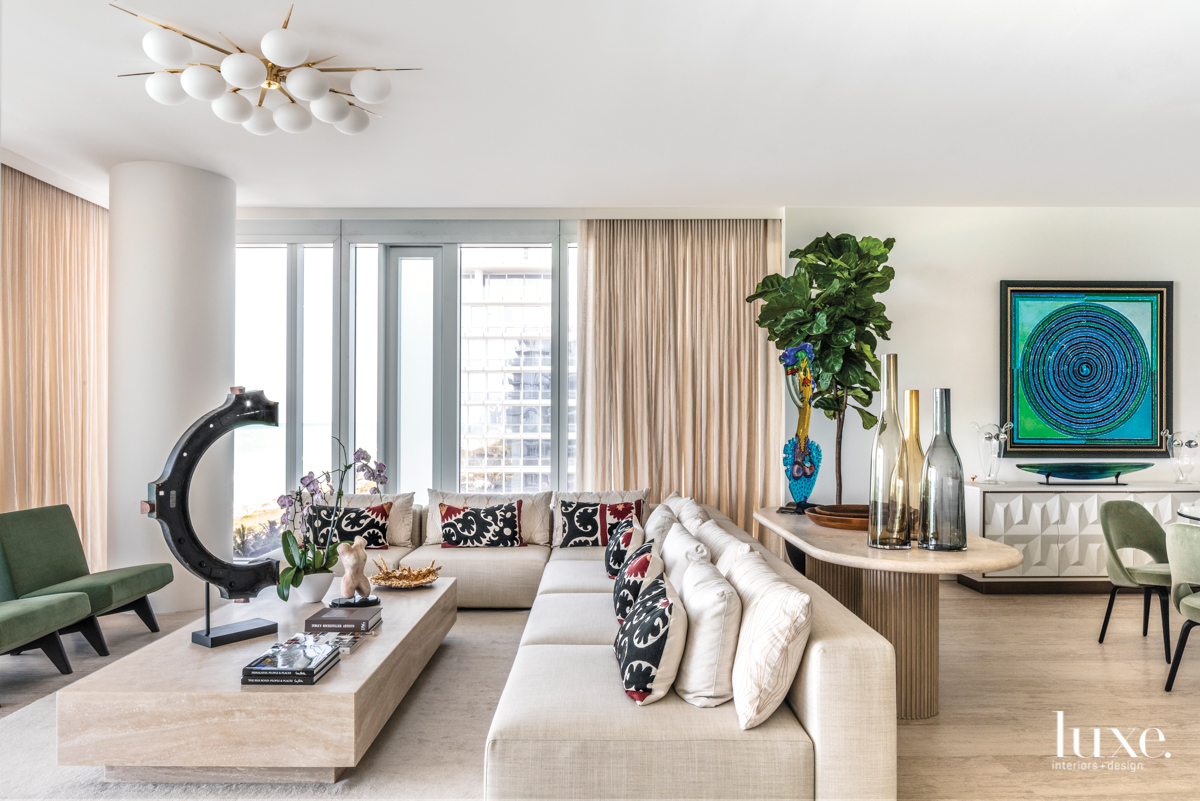 neutral living room with colorful chairs and sofa