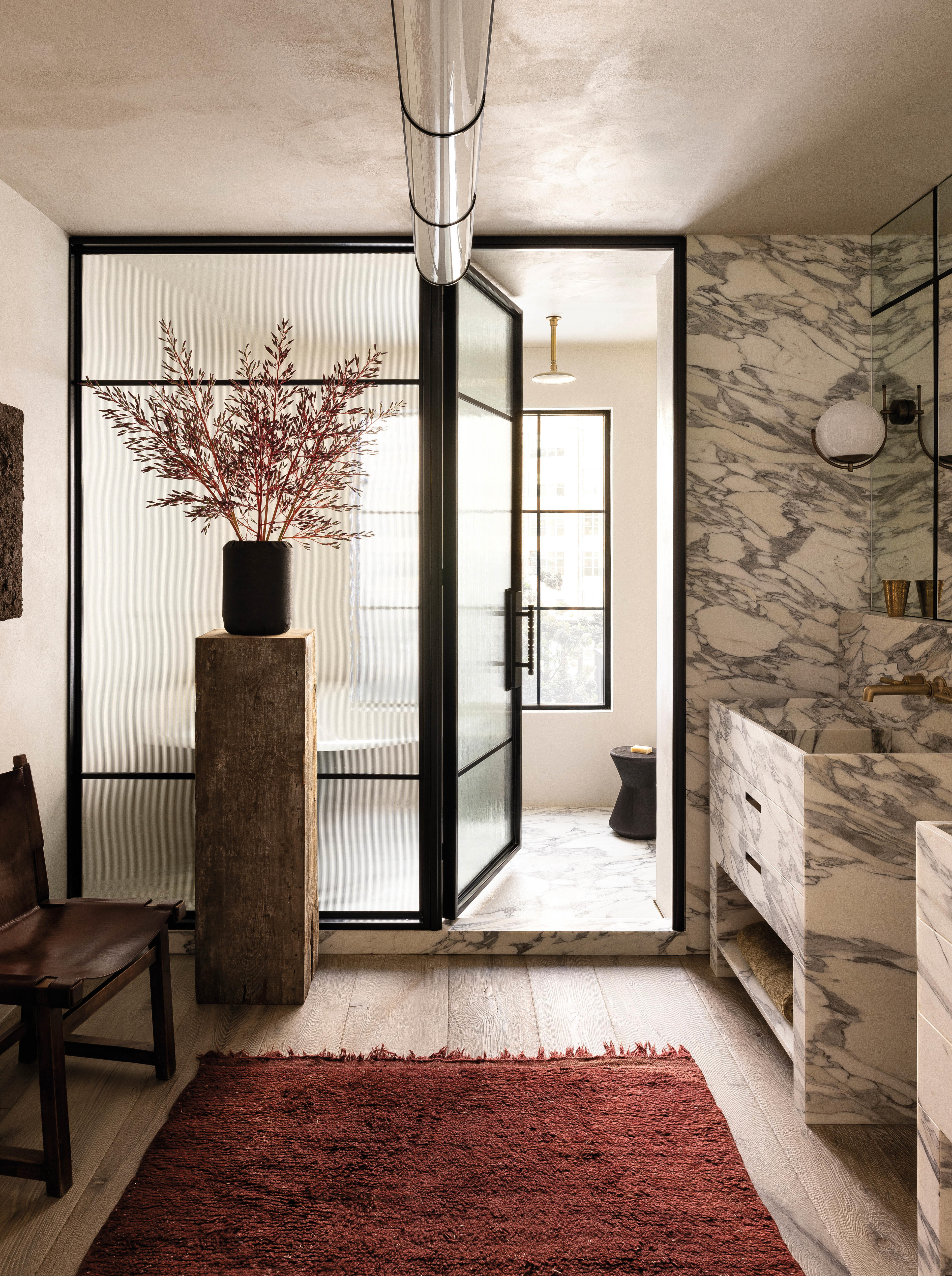 chic bathroom with white and gray marble vanity and shower