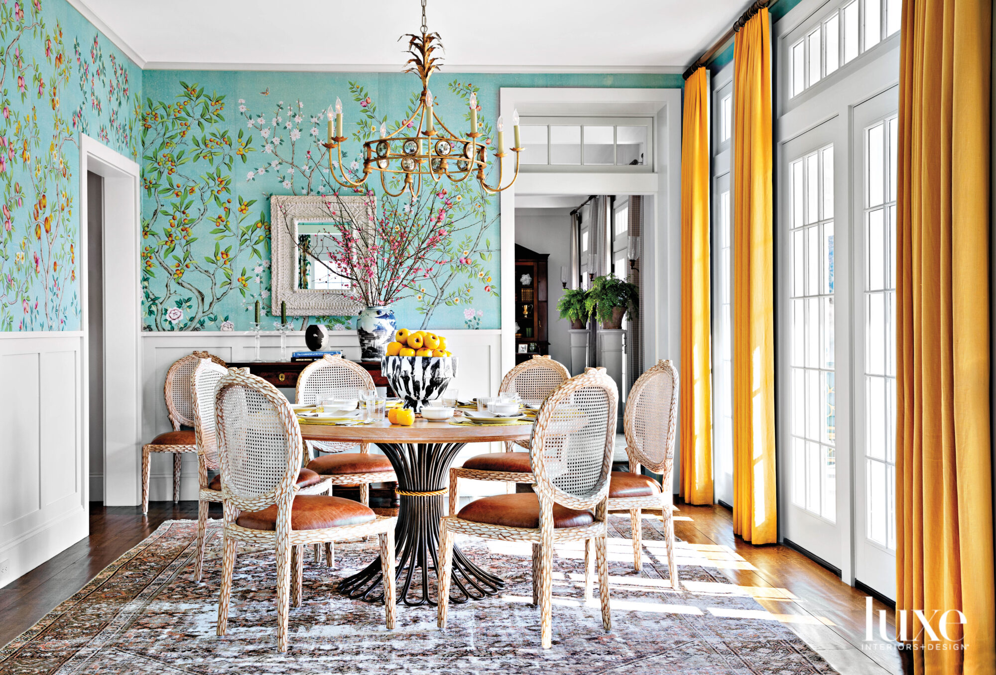 Breakfast room with floral wallpaper and. yellow draperies