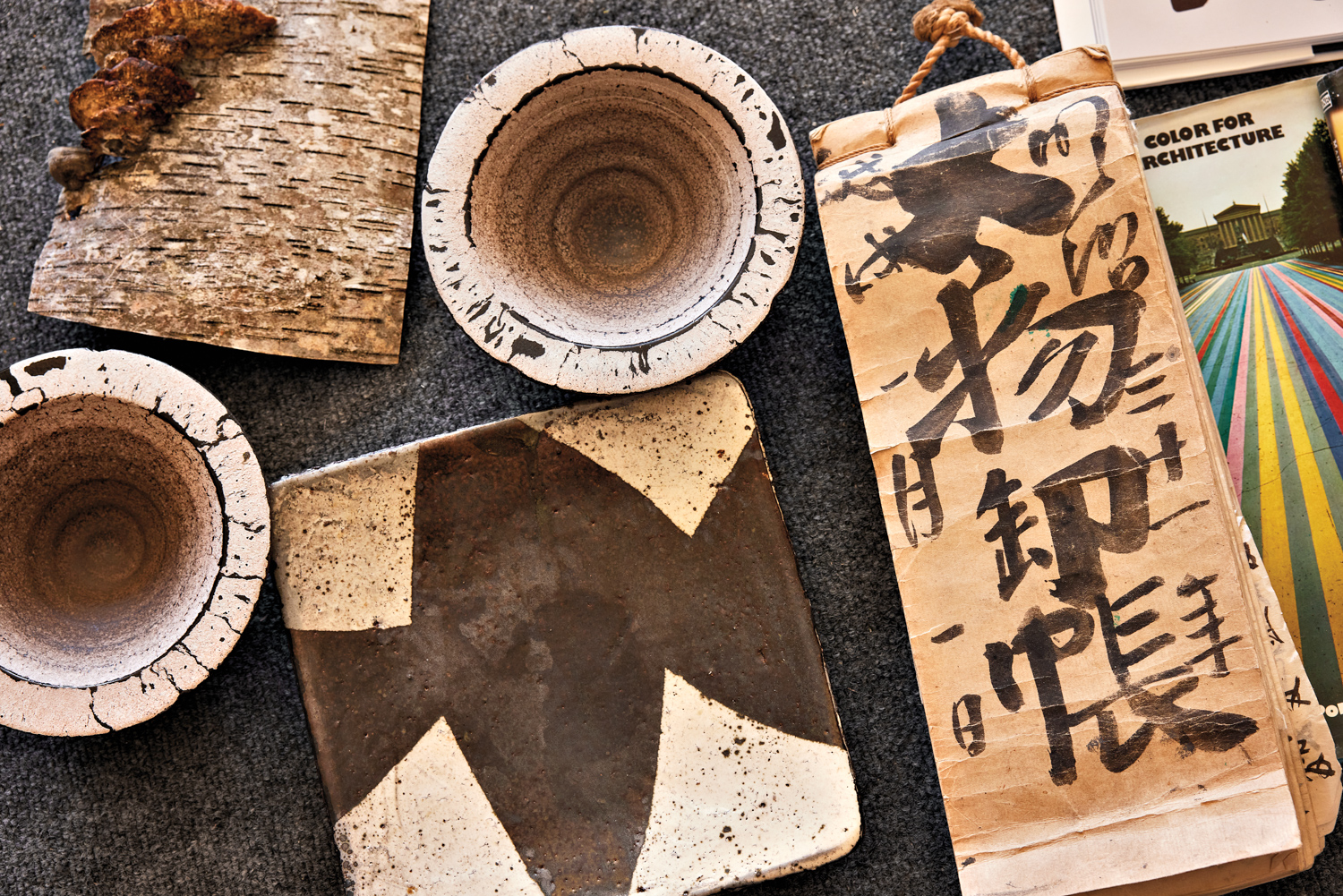 cement art pieces next to kanji print