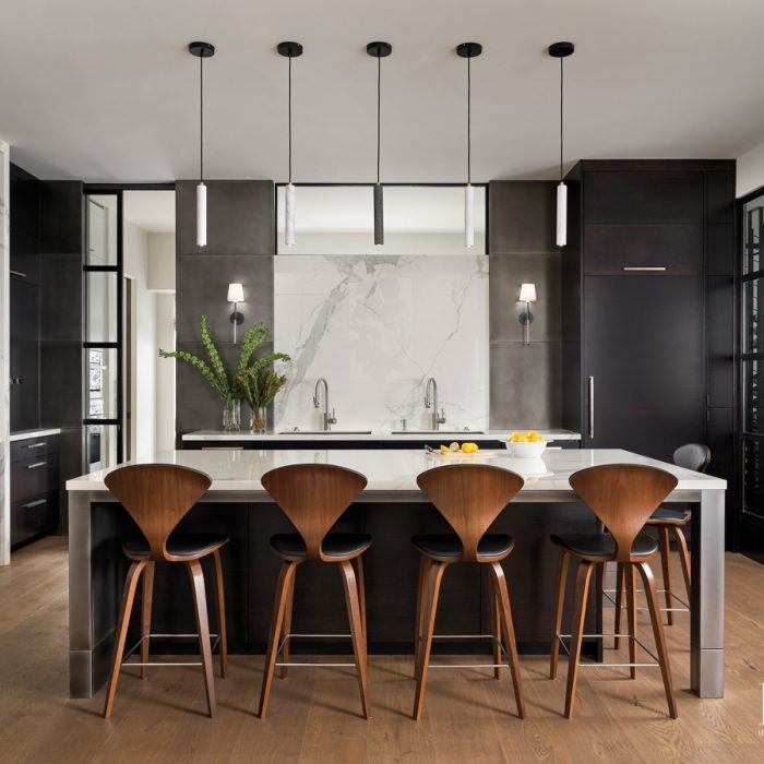 black white kitchen with row of pendants