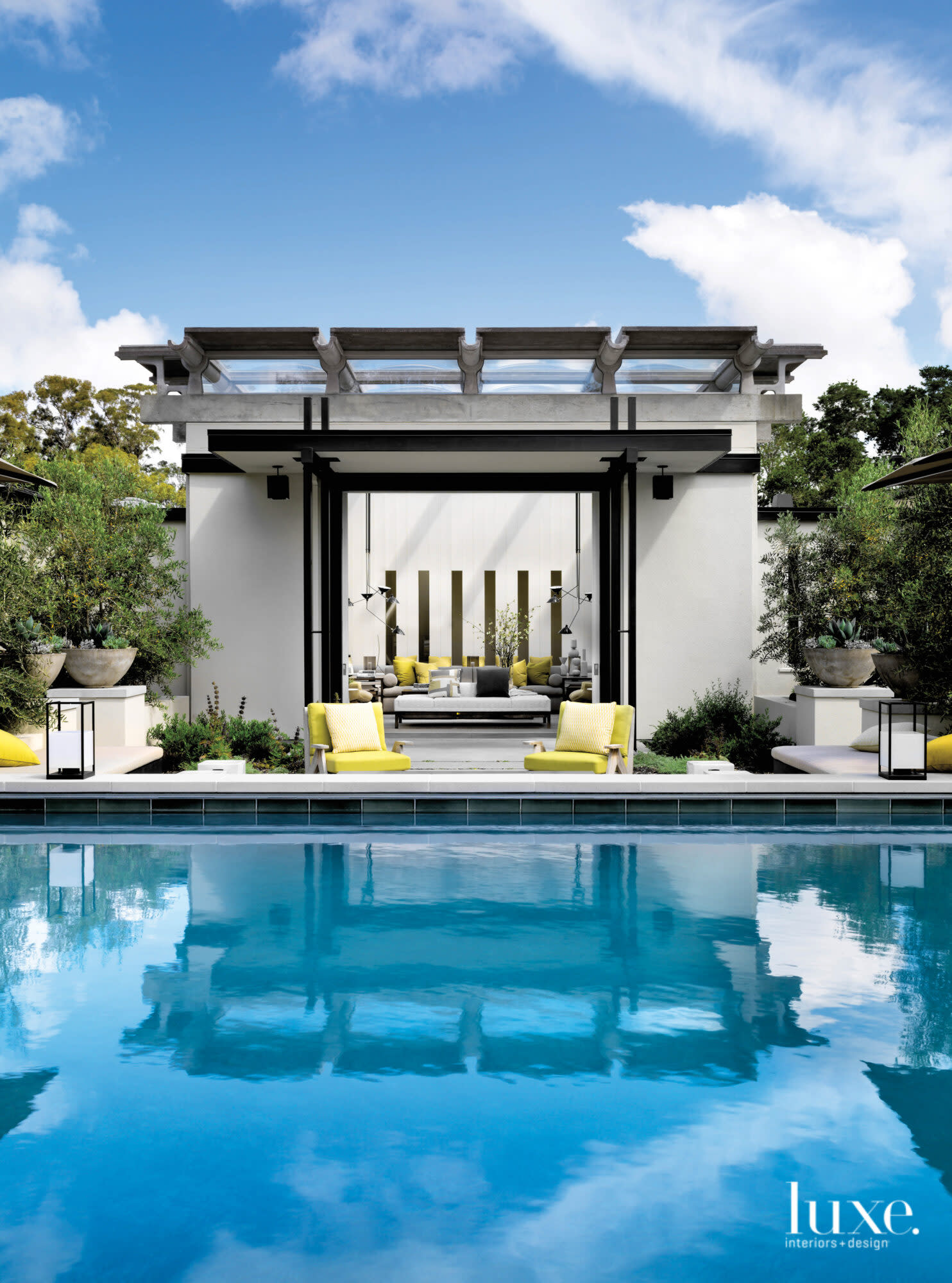 Outside the atrium is a pool and a seating area.