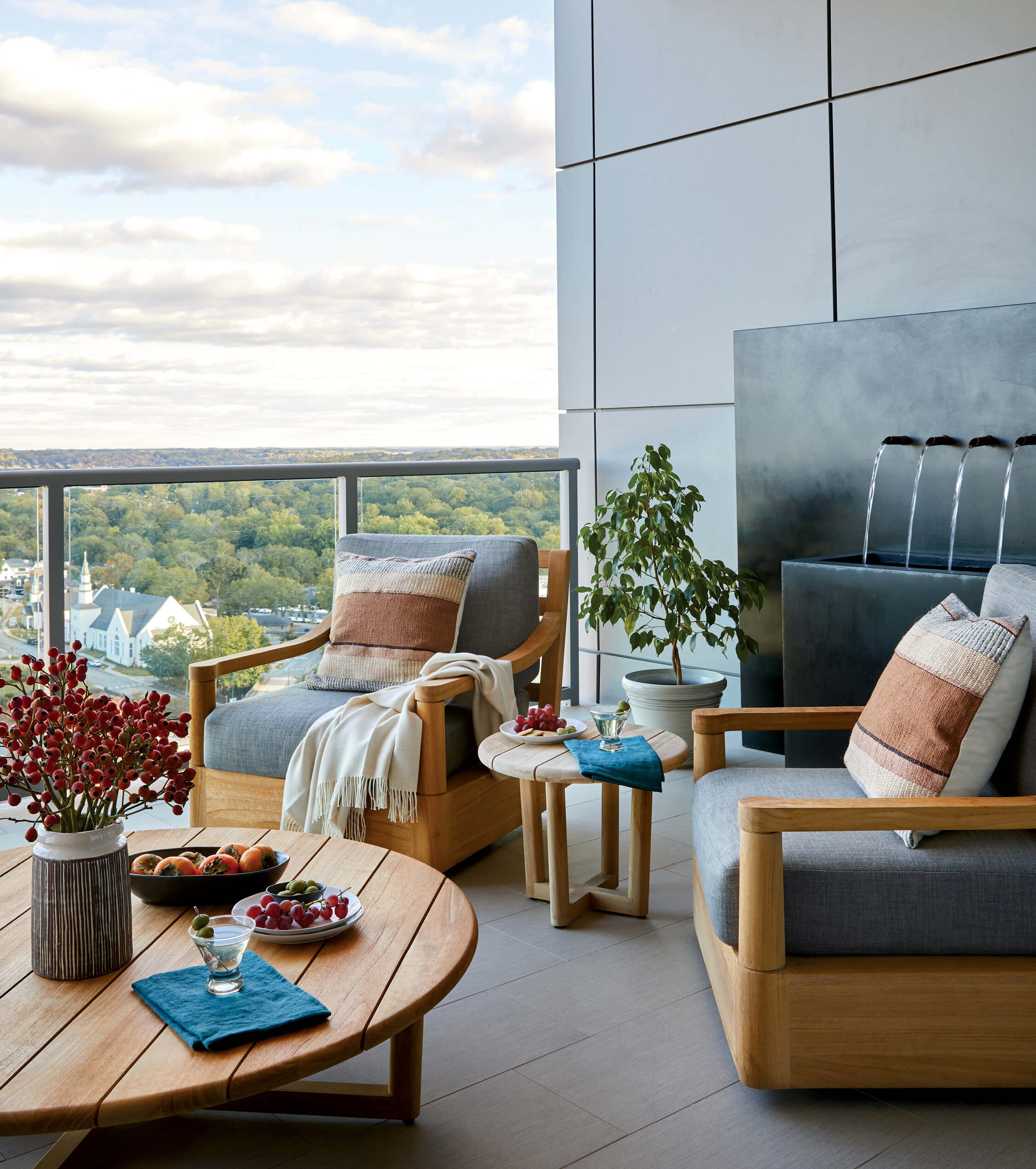 contemporary condo's terrace with teak furniture