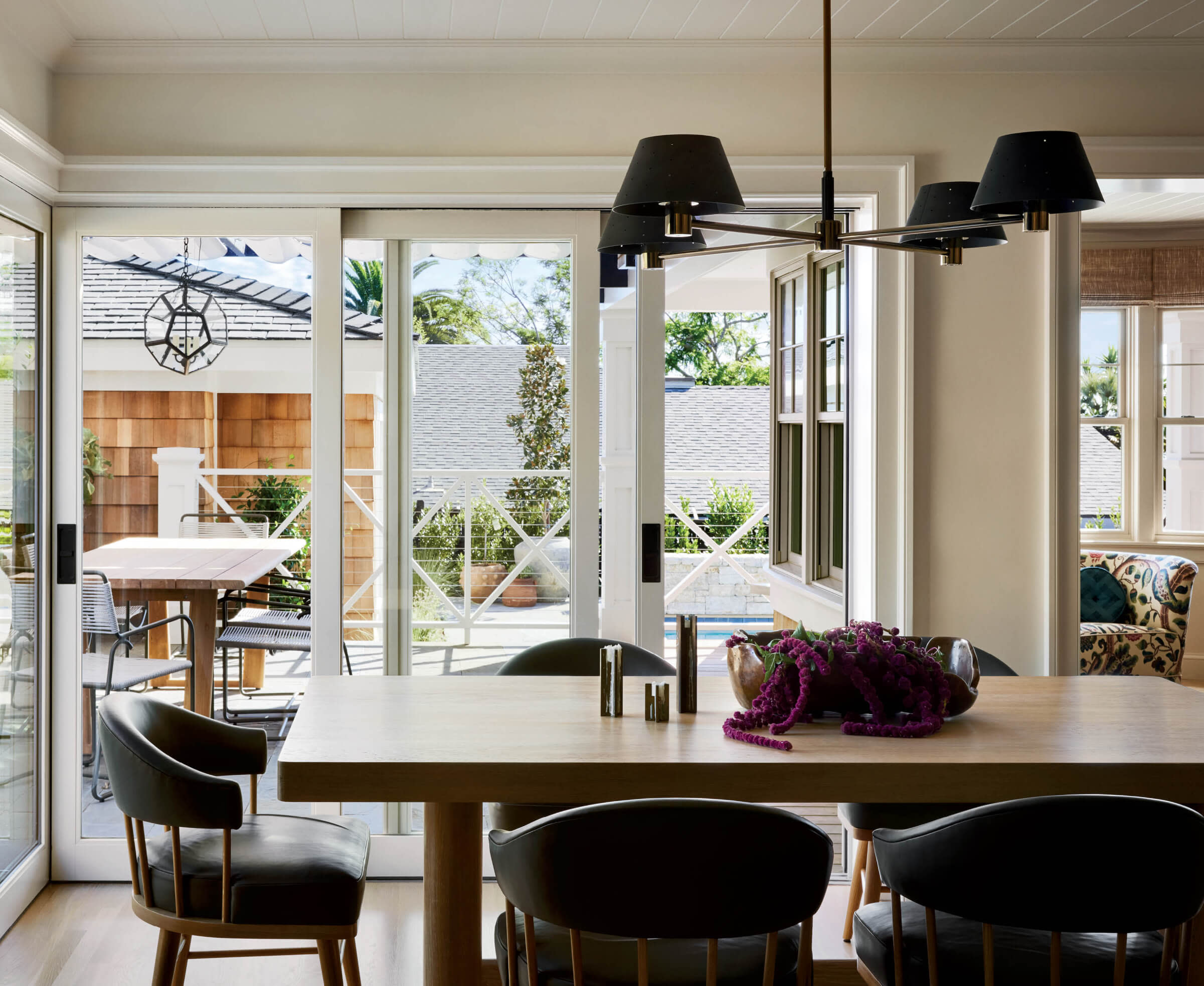 custom white oak table in dining room leading to exteriors