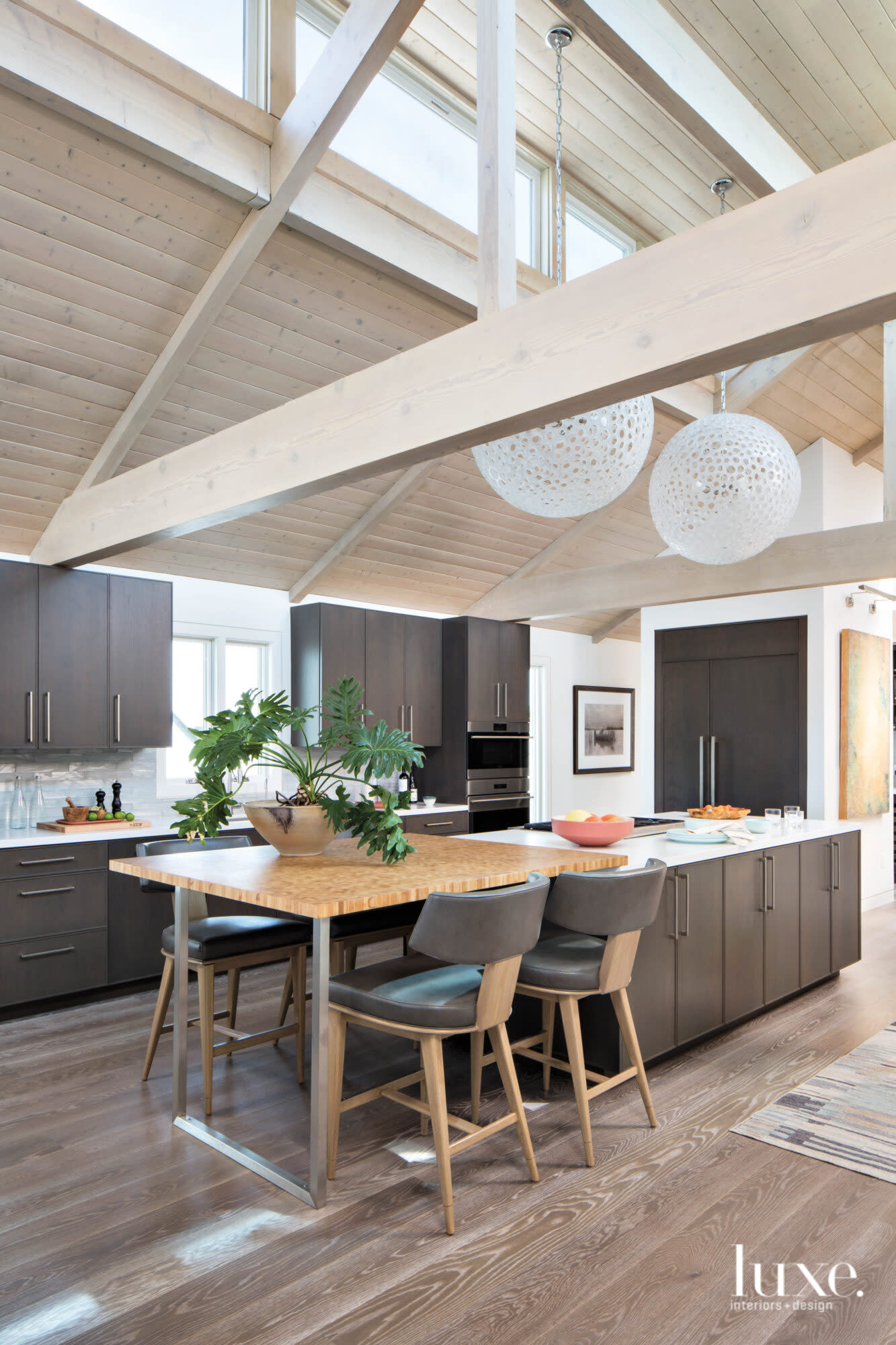 Shot of kitchen with round pendants above the island