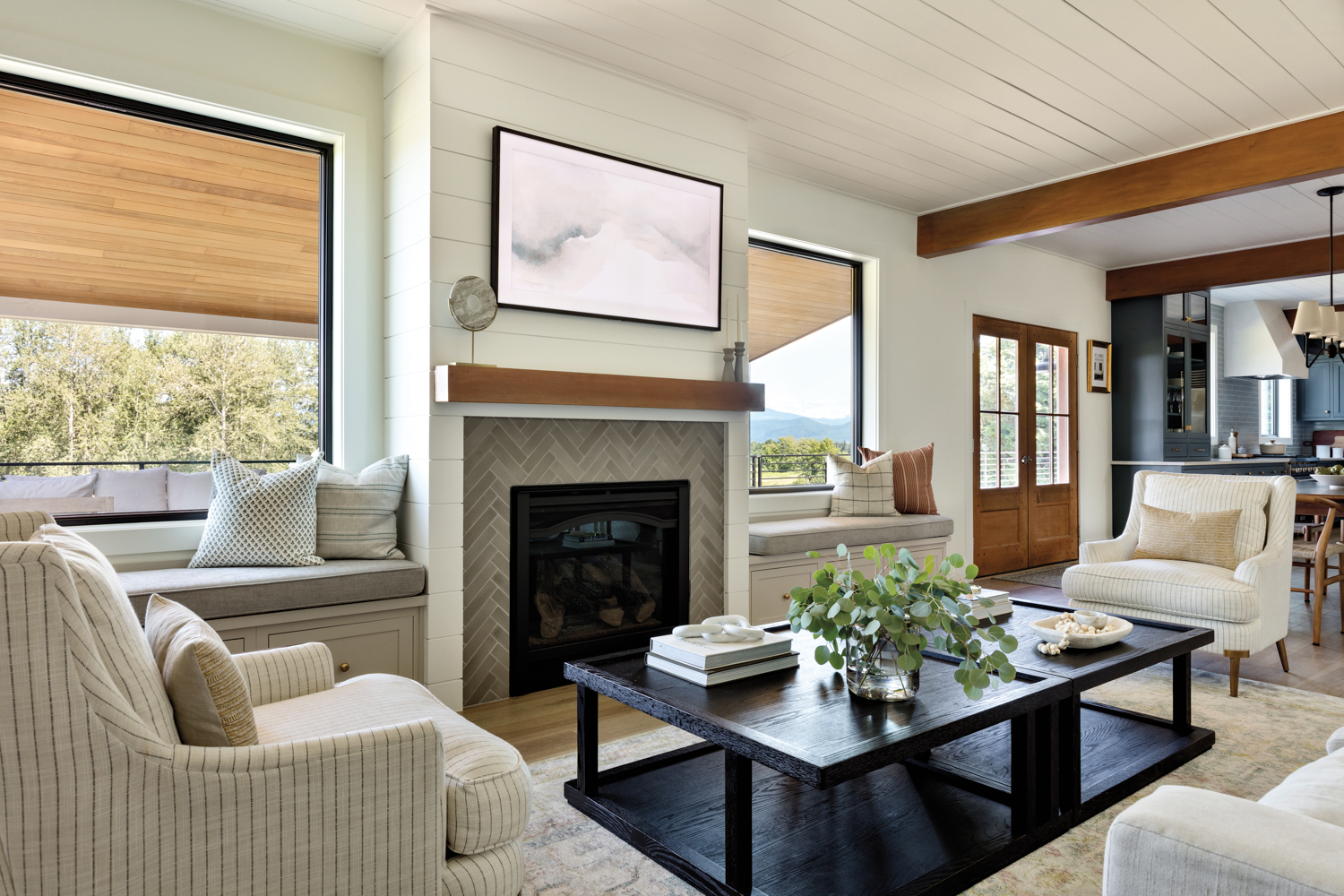 coffee table, upholstered windowsill benches and tiled fireplace in living room by Kimberlee Gorsline