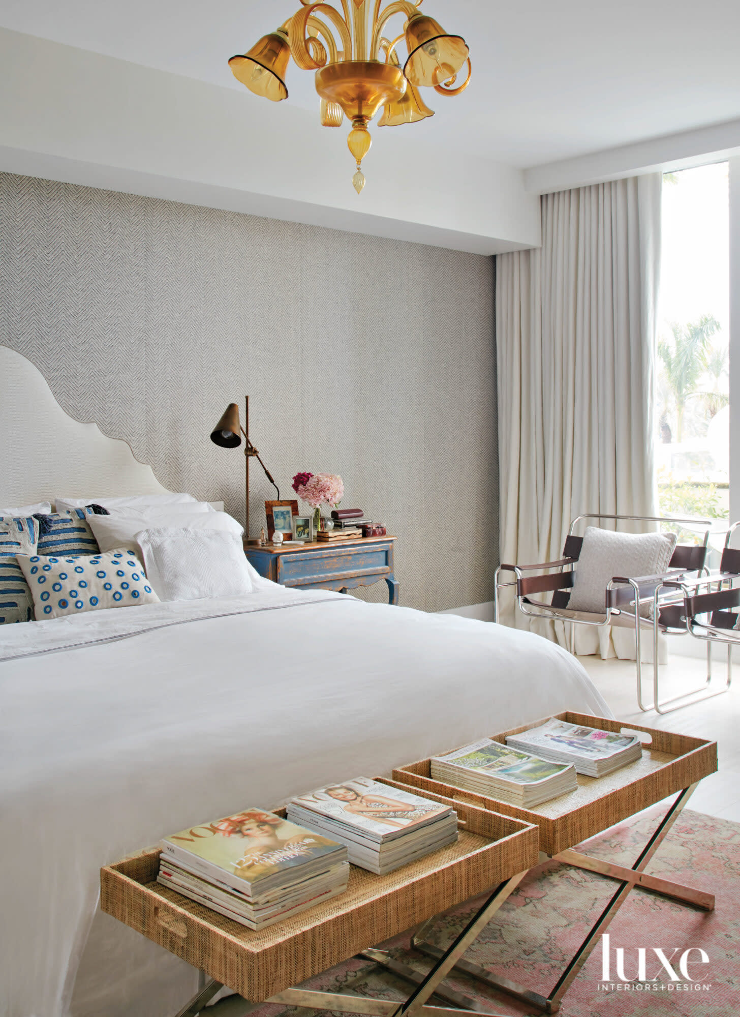 bedroom with gray wall, white bed and yellow Murano chandelier