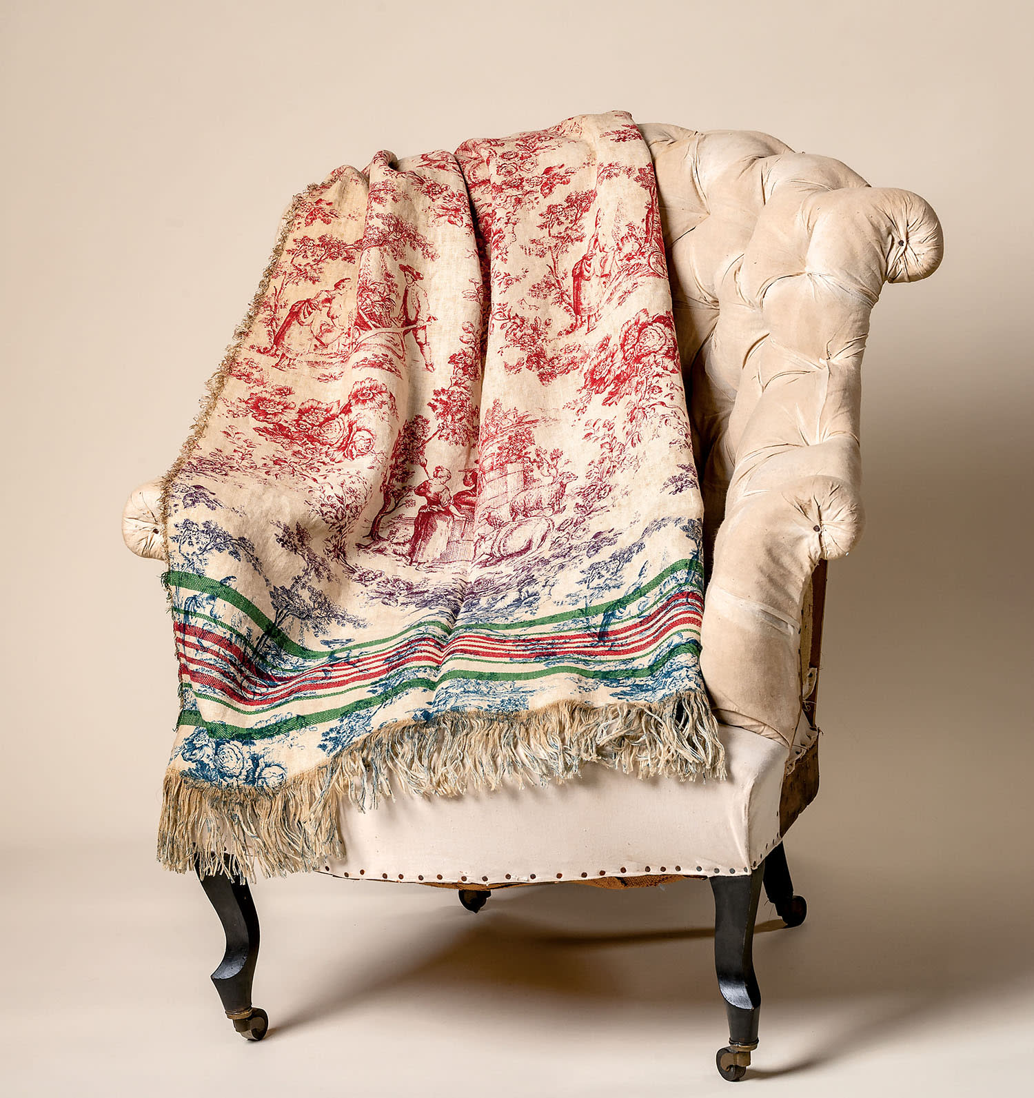 A patterned throw blanked draped on an armchair.
