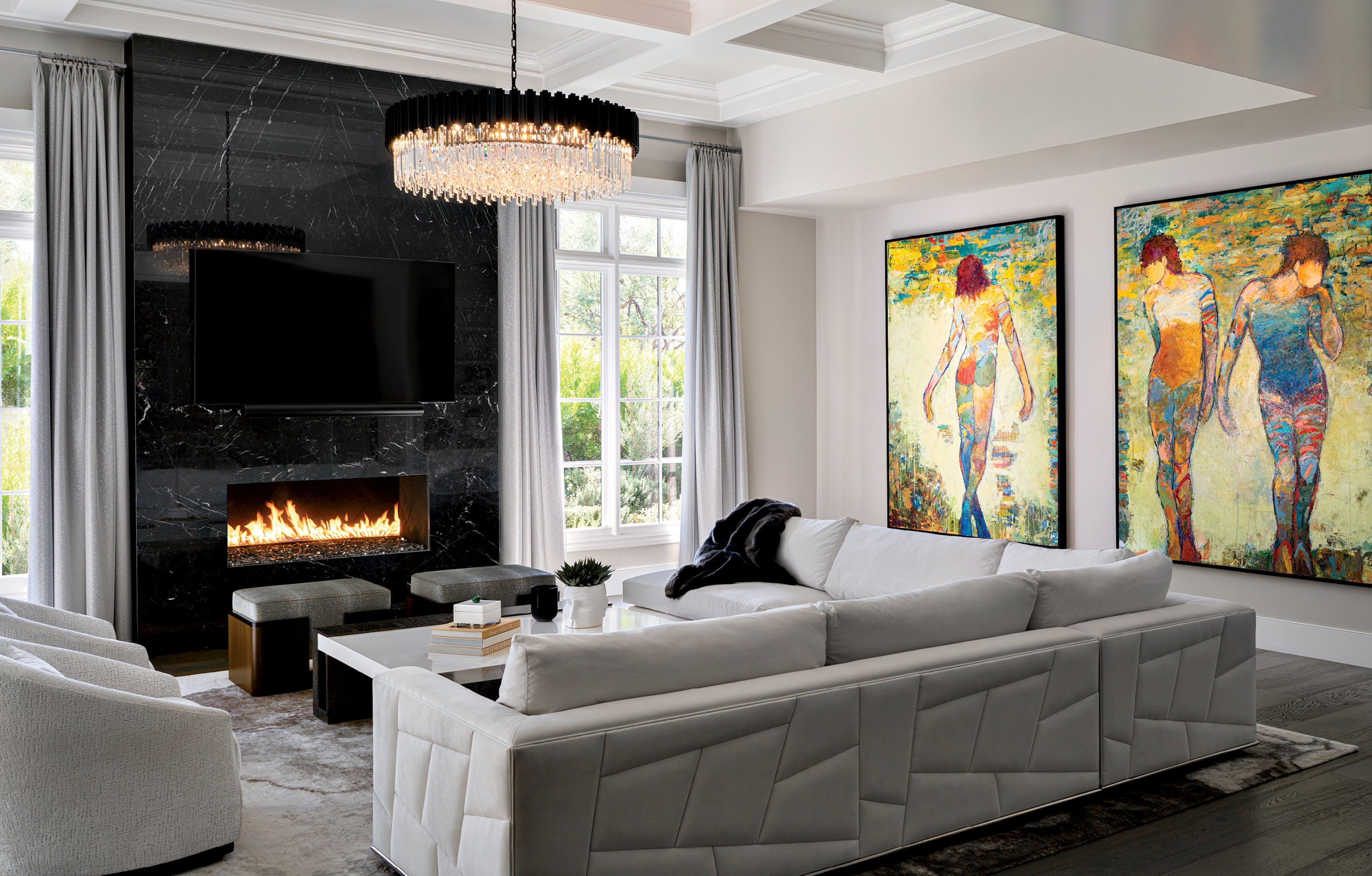 modern living room with a black and white base palette behind bold modern artworks