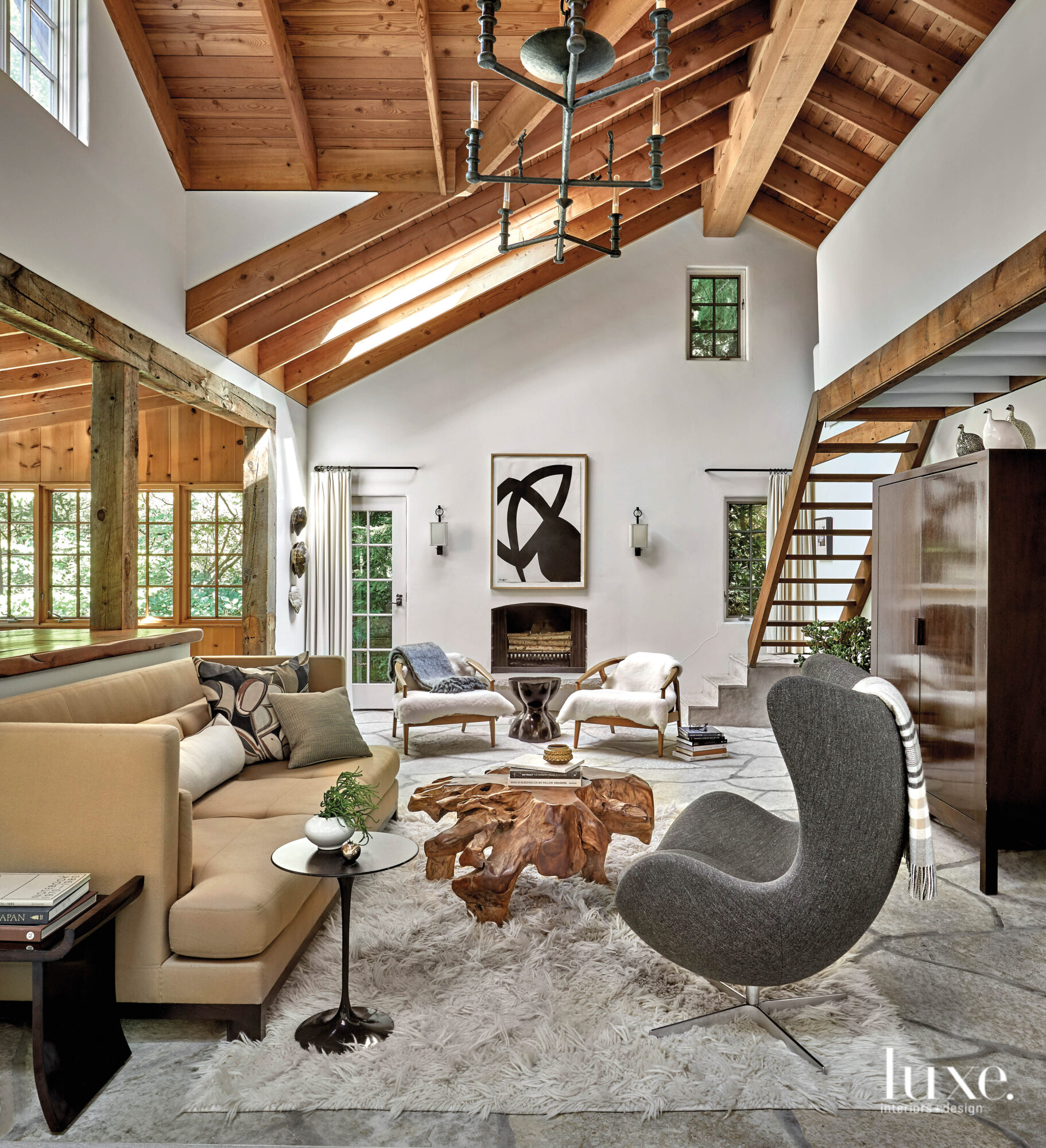 Different yet complementary furniture make this rural cabin living room feel more modern.