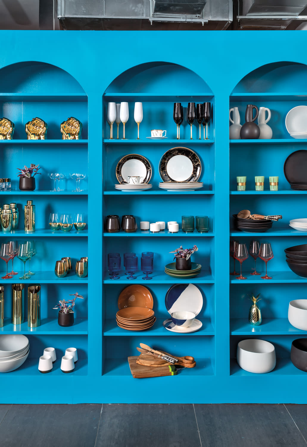 eclectic homewares on vibrant blue shelves in a brick and mortar