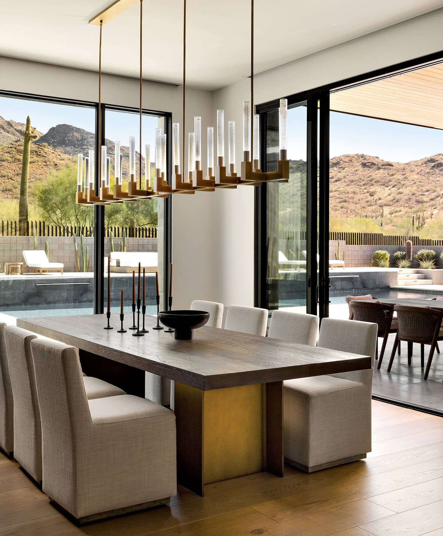 modern, clean-lined dining room with a candlelight-inspired chandelier by Hinkley