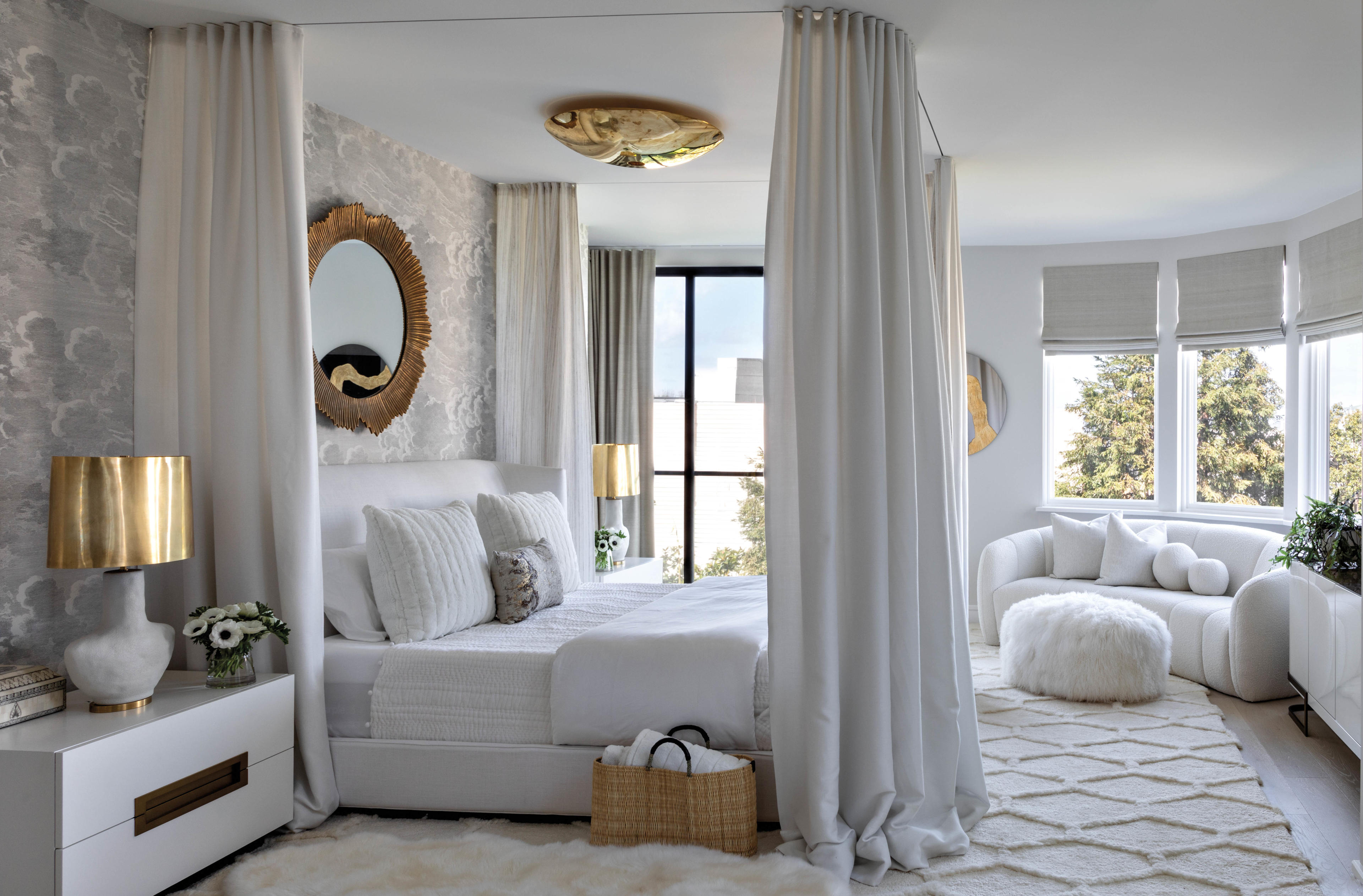 white primary bedroom with bed draped with linen curtains