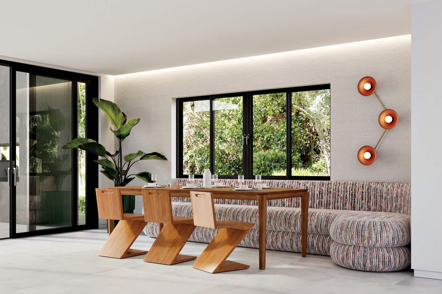 Sculpture light fixture hangs above a banquette with a wooden dining table and 3 geometric chairs