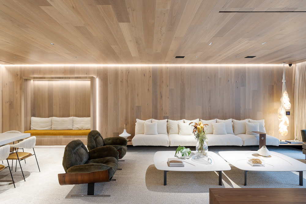 A contemporary living room featuring Euorpean oak floors and sleek white furniture, creating a warm and inviting atmosphere.