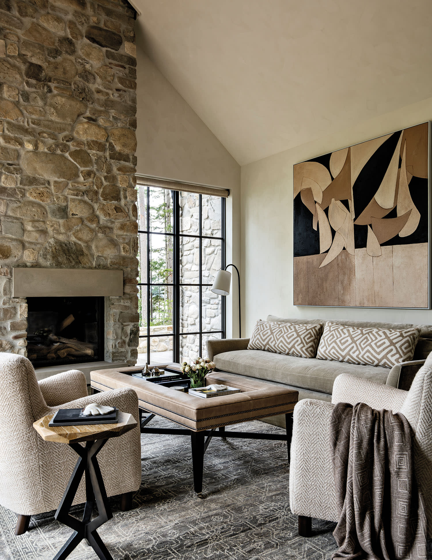 neutral living room with a stone fireplace