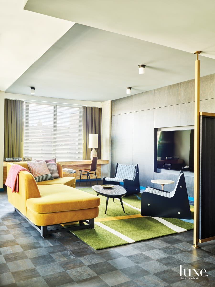 Chicago hotel room with checkered floor, yellow couch and green rug