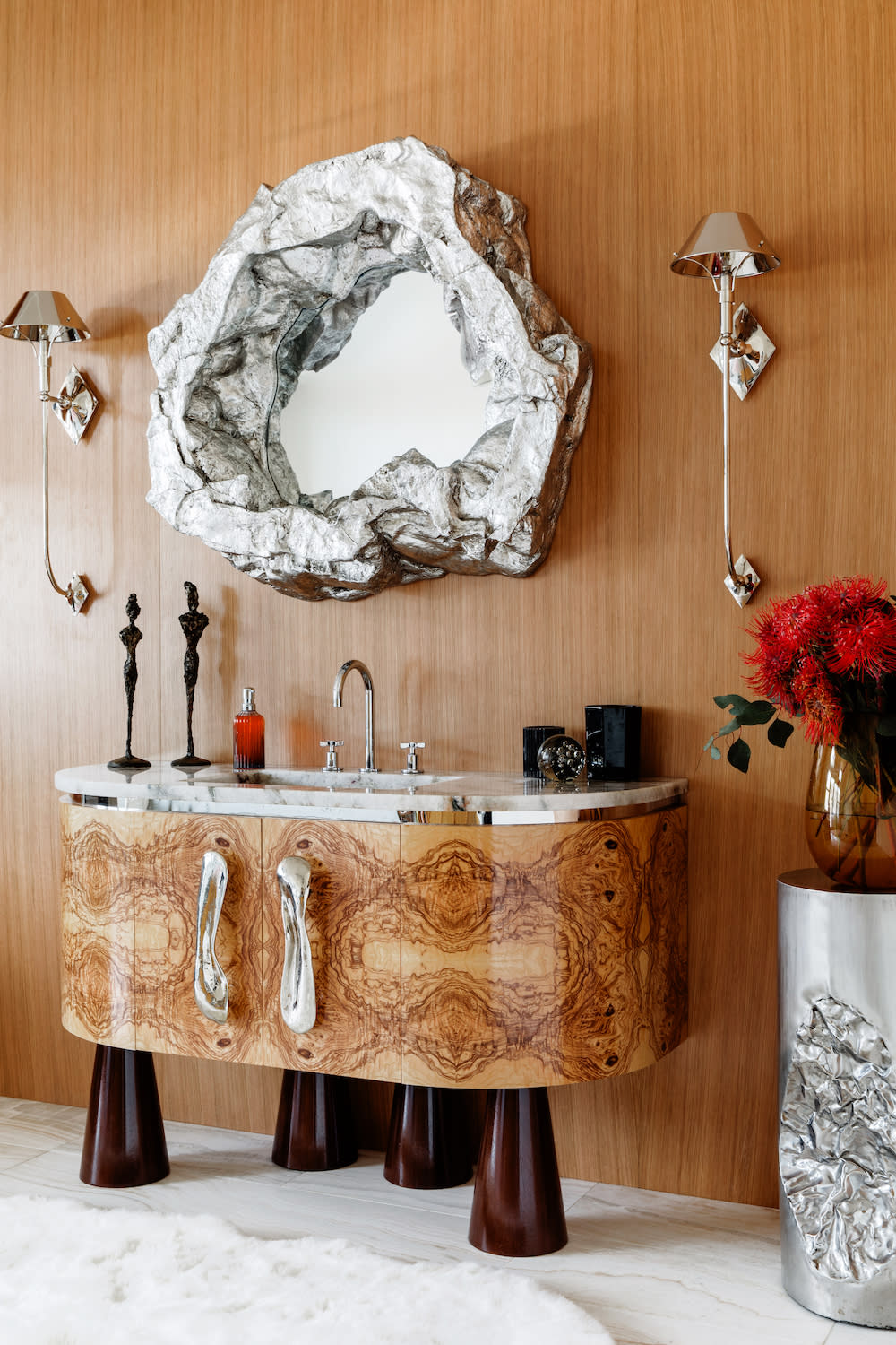 A clean bathroom featuring a mirror above a modern sink, reflecting a bright and inviting atmosphere.