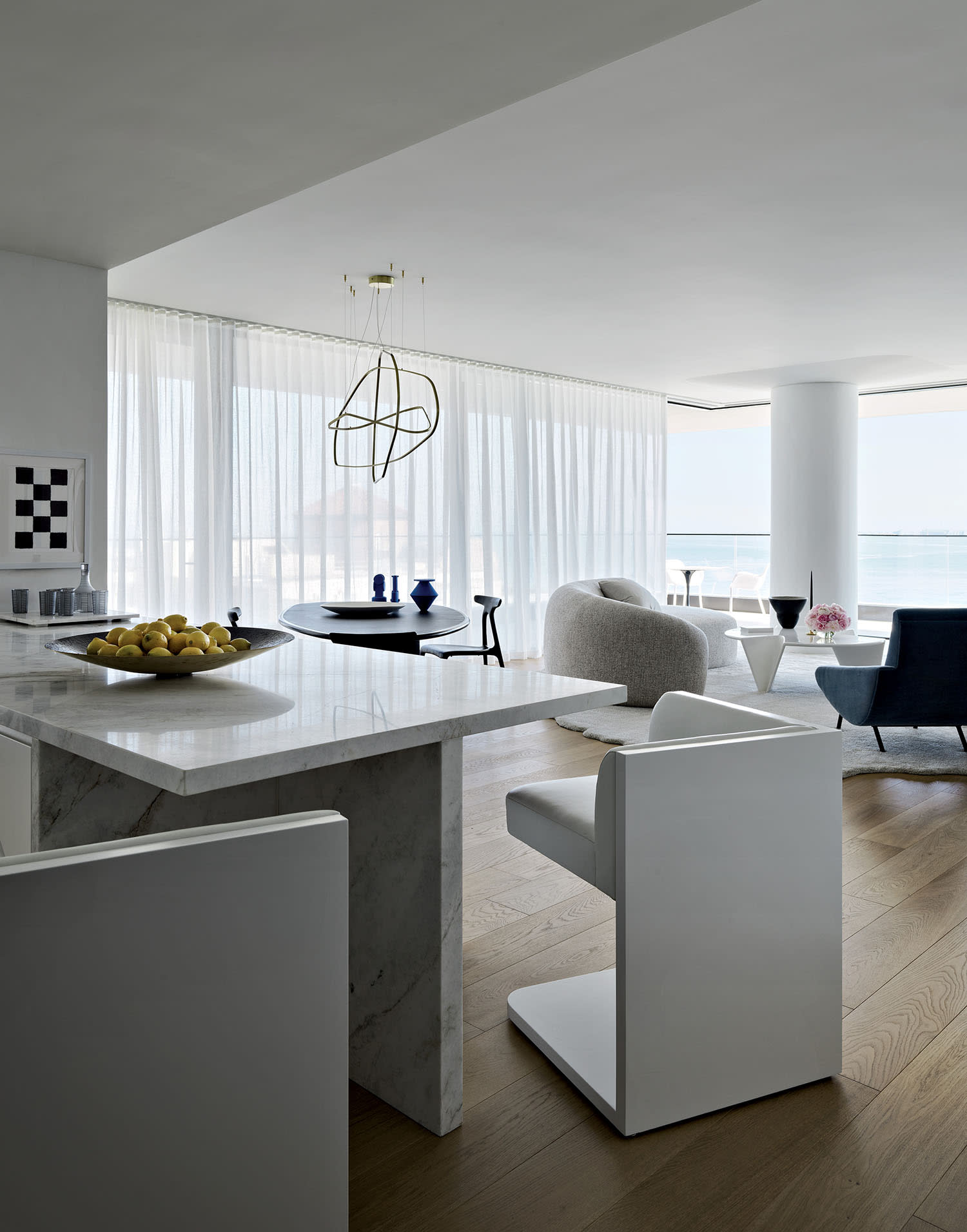 sleek kitchen with counter stools that slide under the island to appear as one single form