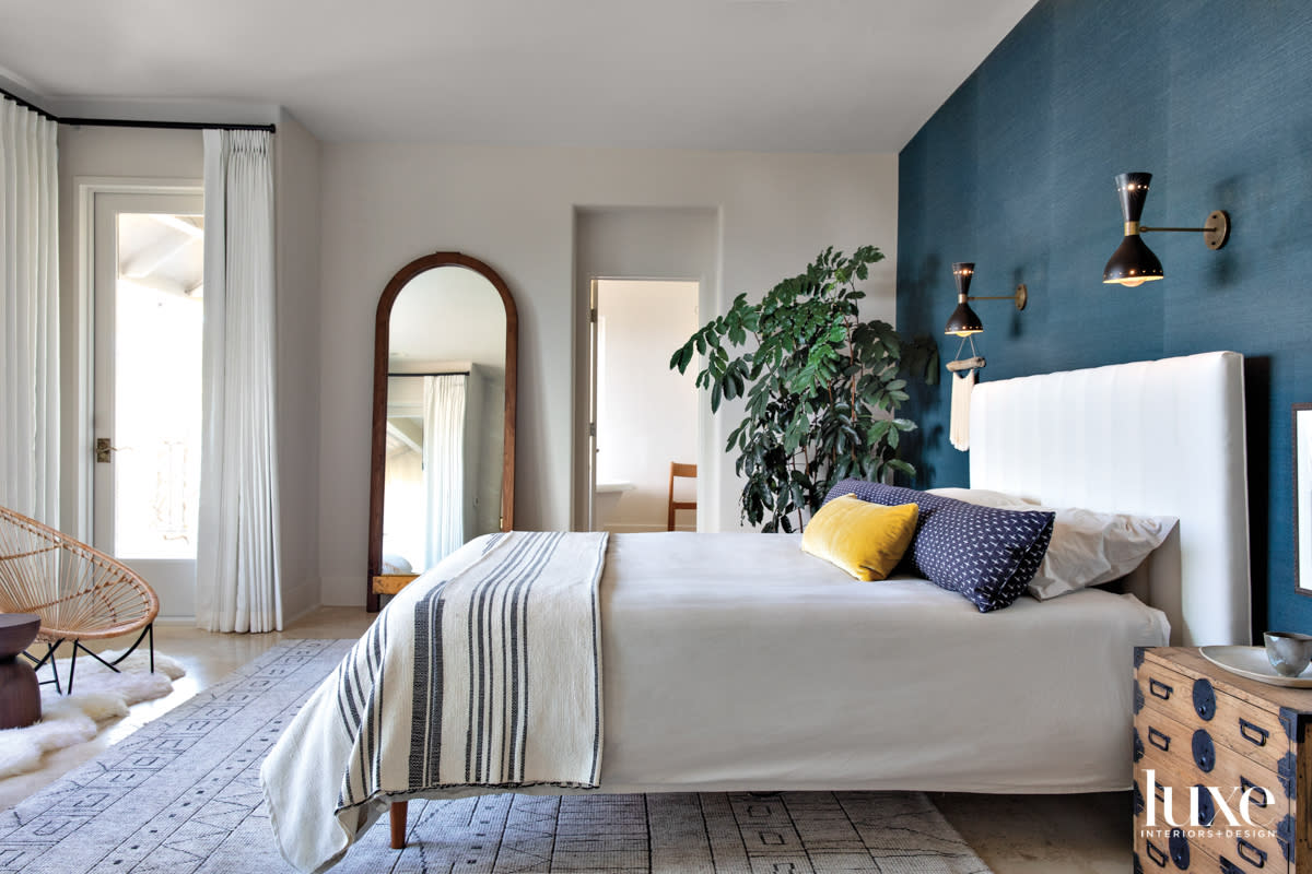 The primary bedroom has a blue accent wall.