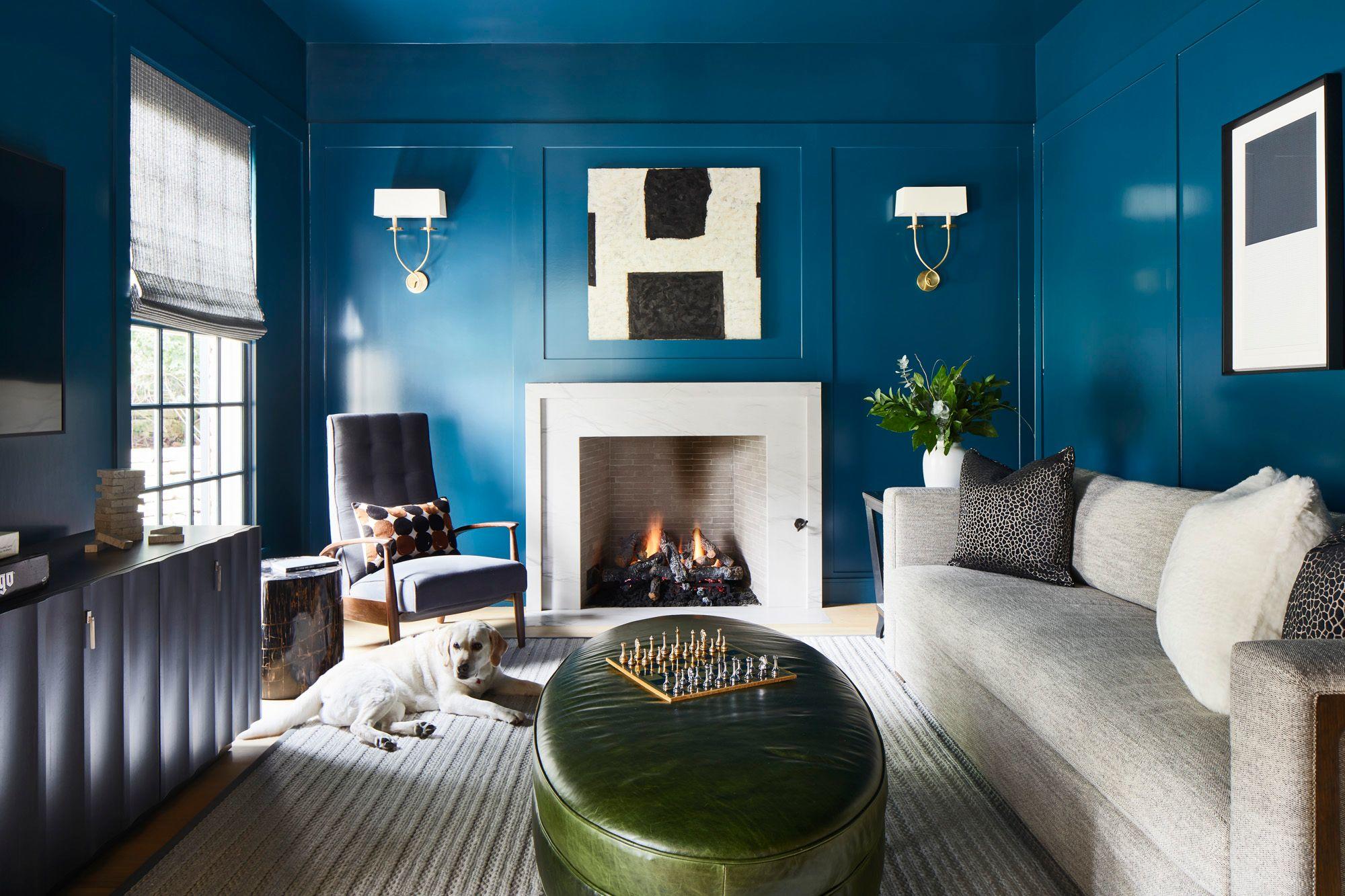 An award-winning remodel featuring rich blue walls with tailored paneling, a striking white fireplace, and an olive green leather ottoman as the centerpiece. Thoughtful decor and layered textures bring timeless charm and modern sophistication.
Photography by Andrea Calo.