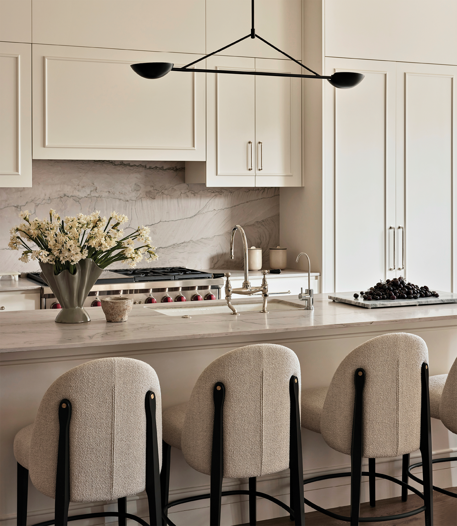 classic kitchen with white cabinetry and a Wolf range