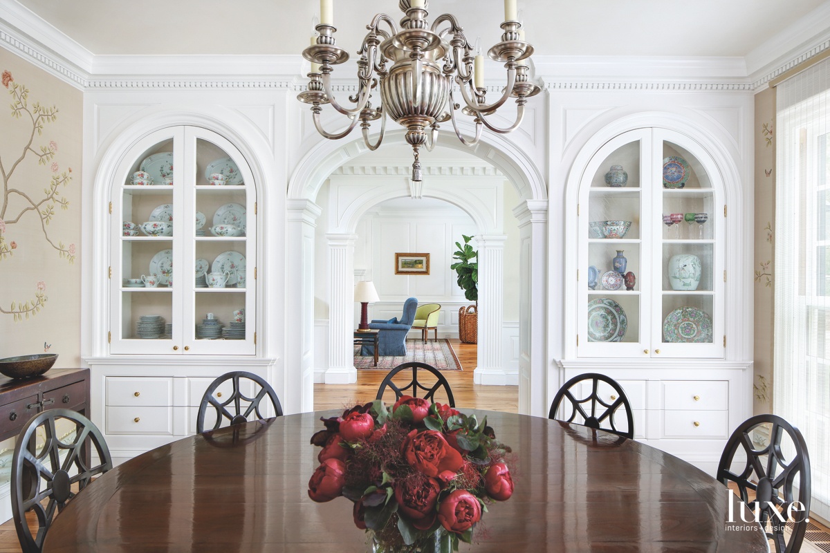 modern dining room round brown table white cabinetry