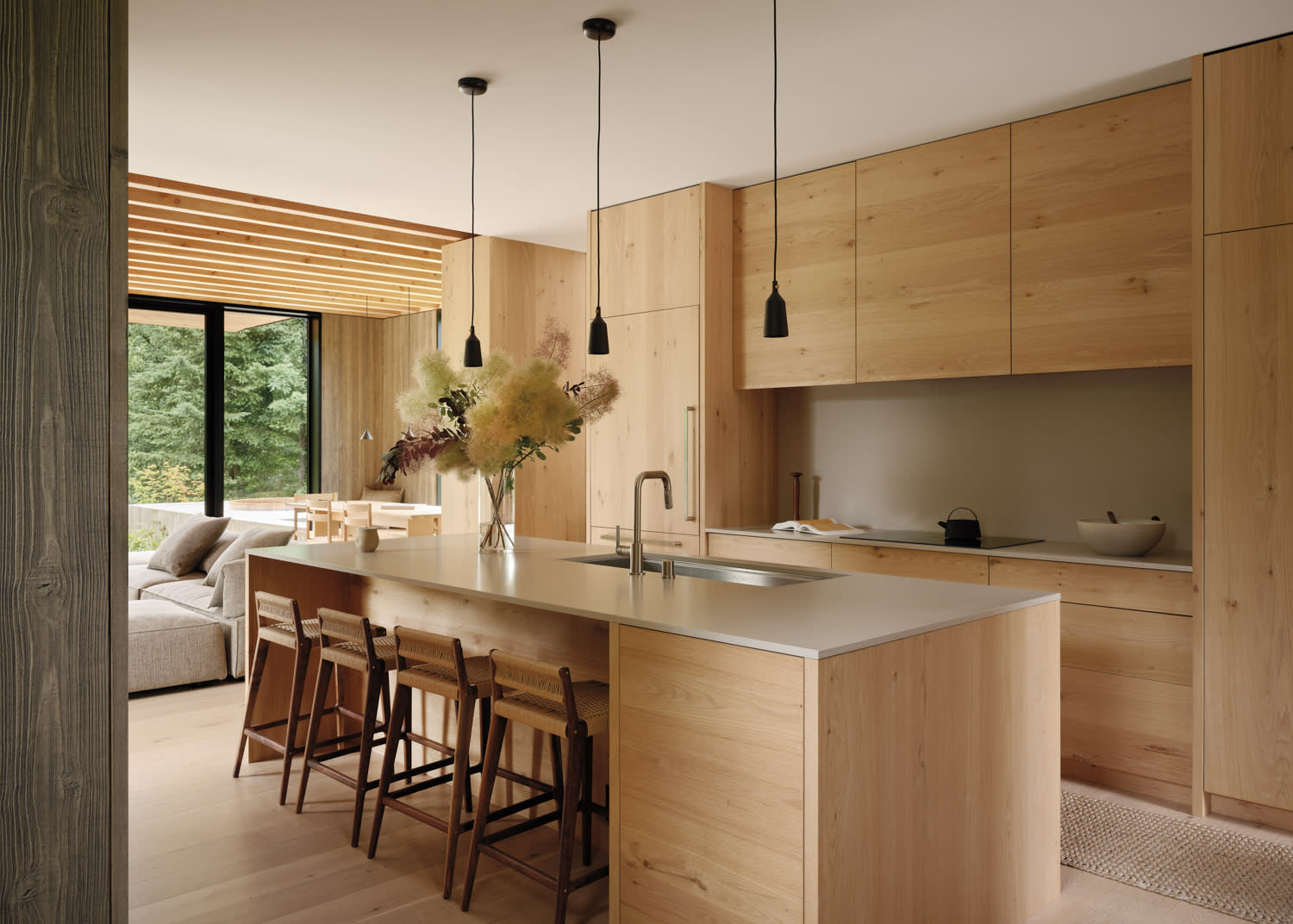 A modern kitchen featuring wooden cabinets and a spacious central island for cooking and dining.