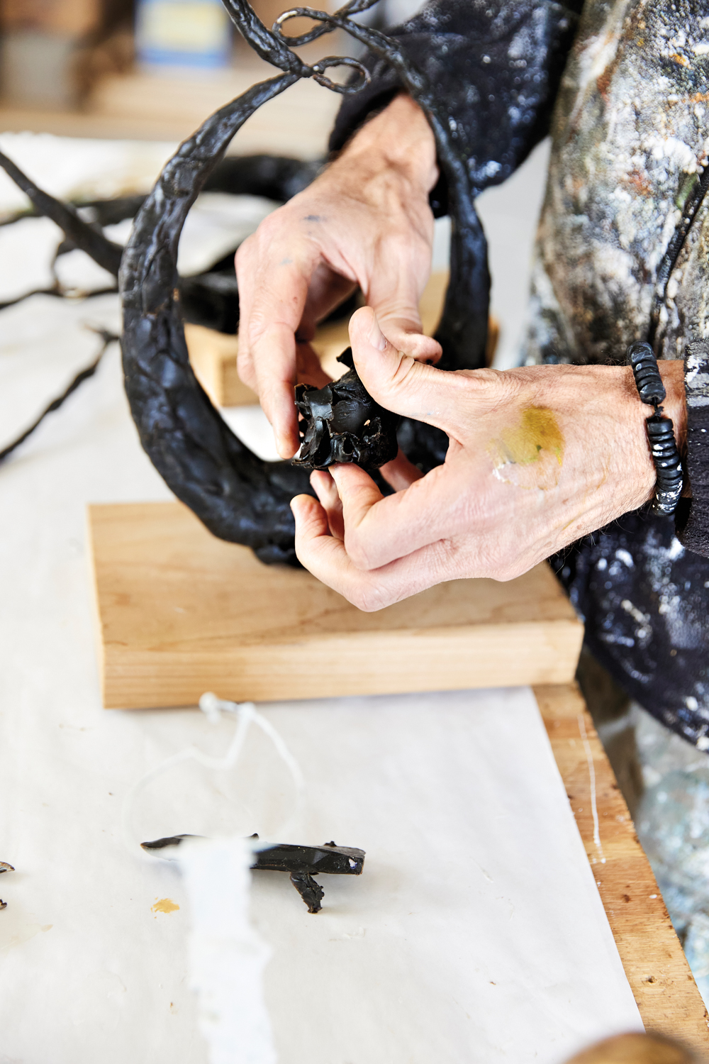 Hands working with sculpture